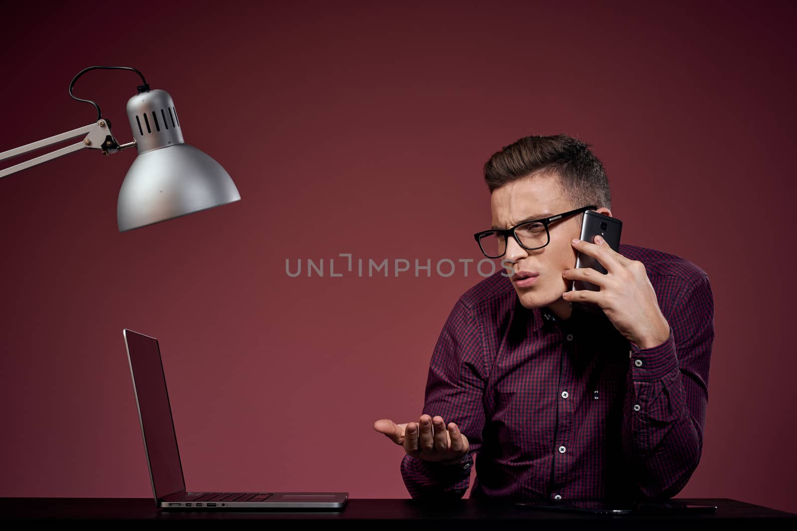 Business man in office and talking on the phone manager red background model cropped view of laptop tablet. High quality photo