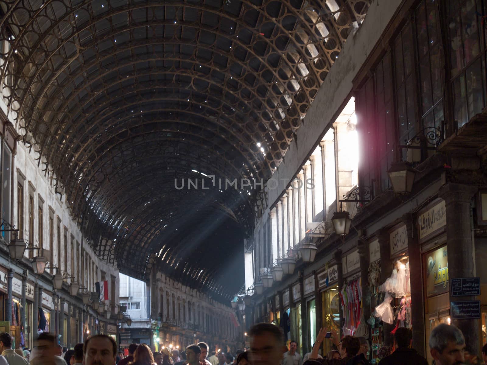 The Al-Hamidiyah Souq, Damascus Syria 04/12/2009 the main market in the Old City. All goods, foods, clothes, jewelry were on sale here.Before the war this was the busiest souk in Syria with the Umaayad Mosque at one end. Famous for it's arched tin roof. High quality photo