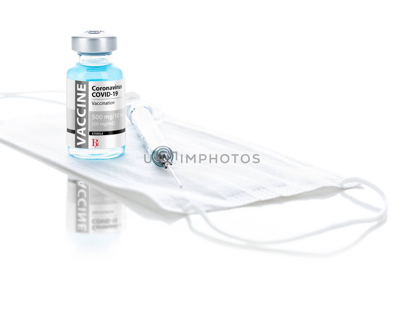 Coronavirus COVID-19 Vaccine Vial, Syringe and Medical Face Mask On Reflective White Background.