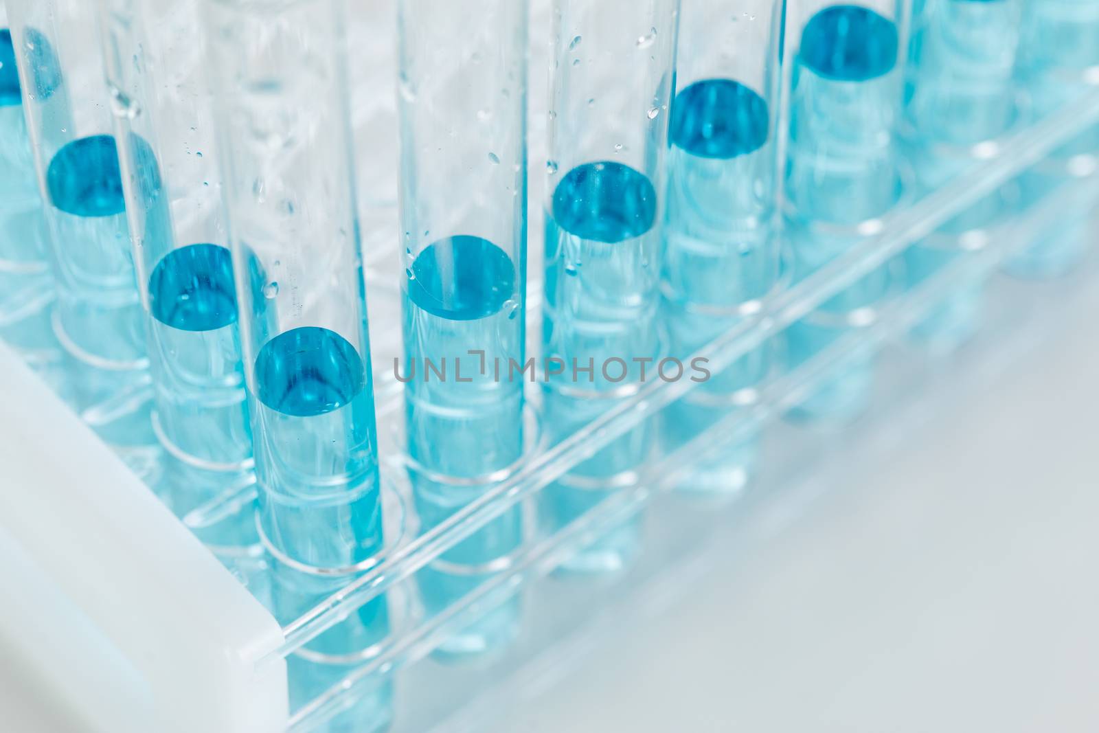 Abstract of Scientific Test Tubes Containing Blue Chemical In Ra by Feverpitched
