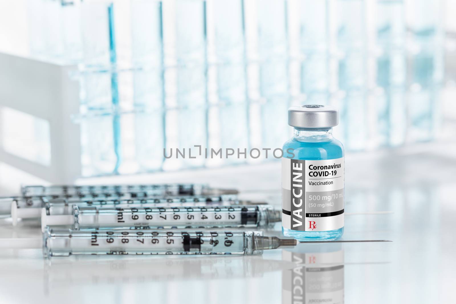 Coronavirus COVID-19 Vaccine Vial and Several Syringes On Reflective Surface Near Test Tubes.