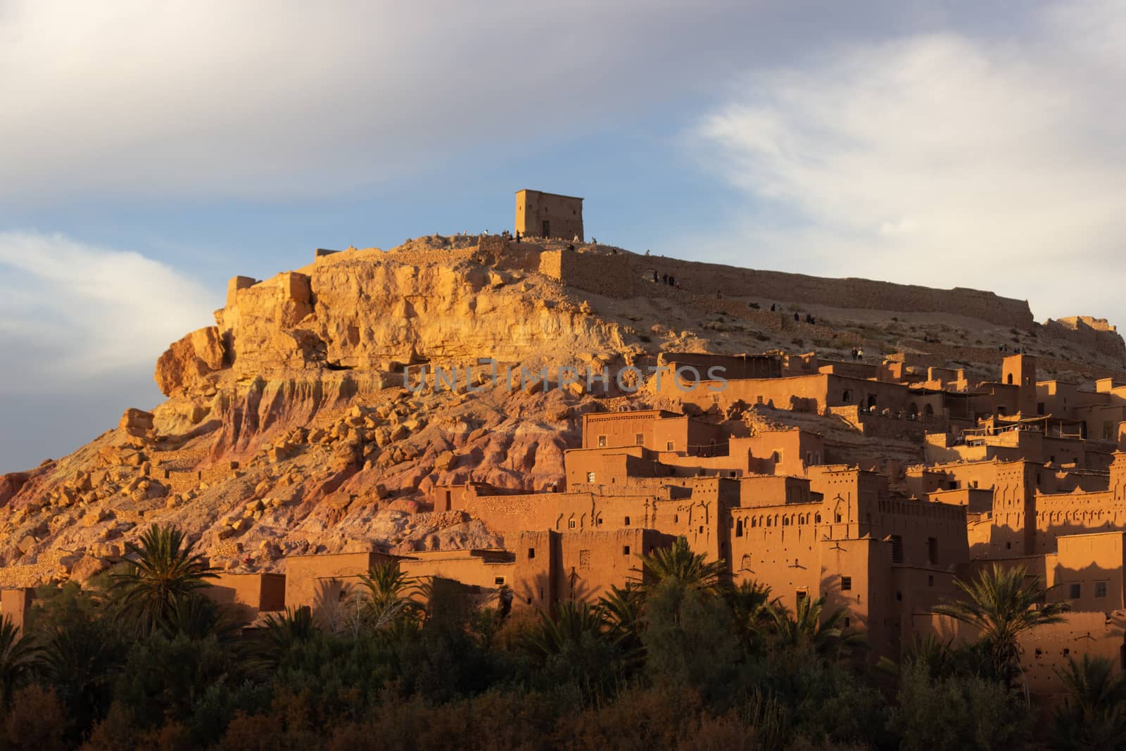 Ait Ben Haddou ksar Morocco, ancient fortress that is a Unesco Heritage site. Beautiful late afternoon light with honey, gold coloured mud brick construction the kasbah, or fortified town dates from 11th cent. and is on the former caravan route from the Sahara and Marrakech. The location has been used for many famous movies. High quality photo