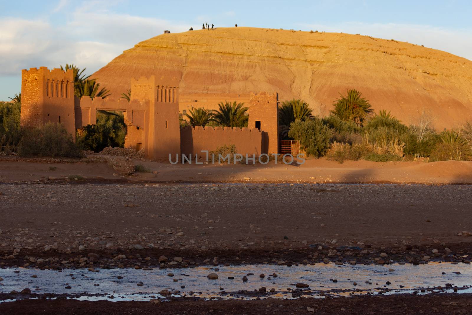 Ait Ben Haddou ksar Morocco, ancient fortress that is a Unesco Heritage site. Beautiful late afternoon light with honey, gold coloured mud brick construction the kasbah, or fortified town dates from 11th cent. and is on the former caravan route from the Sahara and Marrakech. The location has been used for many famous movies. High quality photo