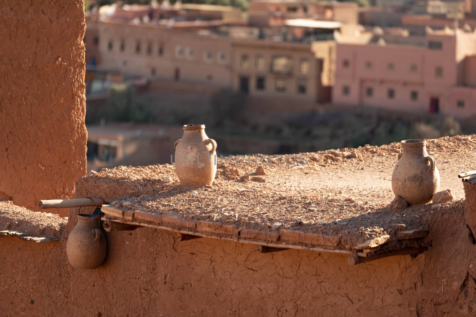 Ancient pots on wall at Ait Ben Haddou ksar Morocco, the new town is in background by kgboxford