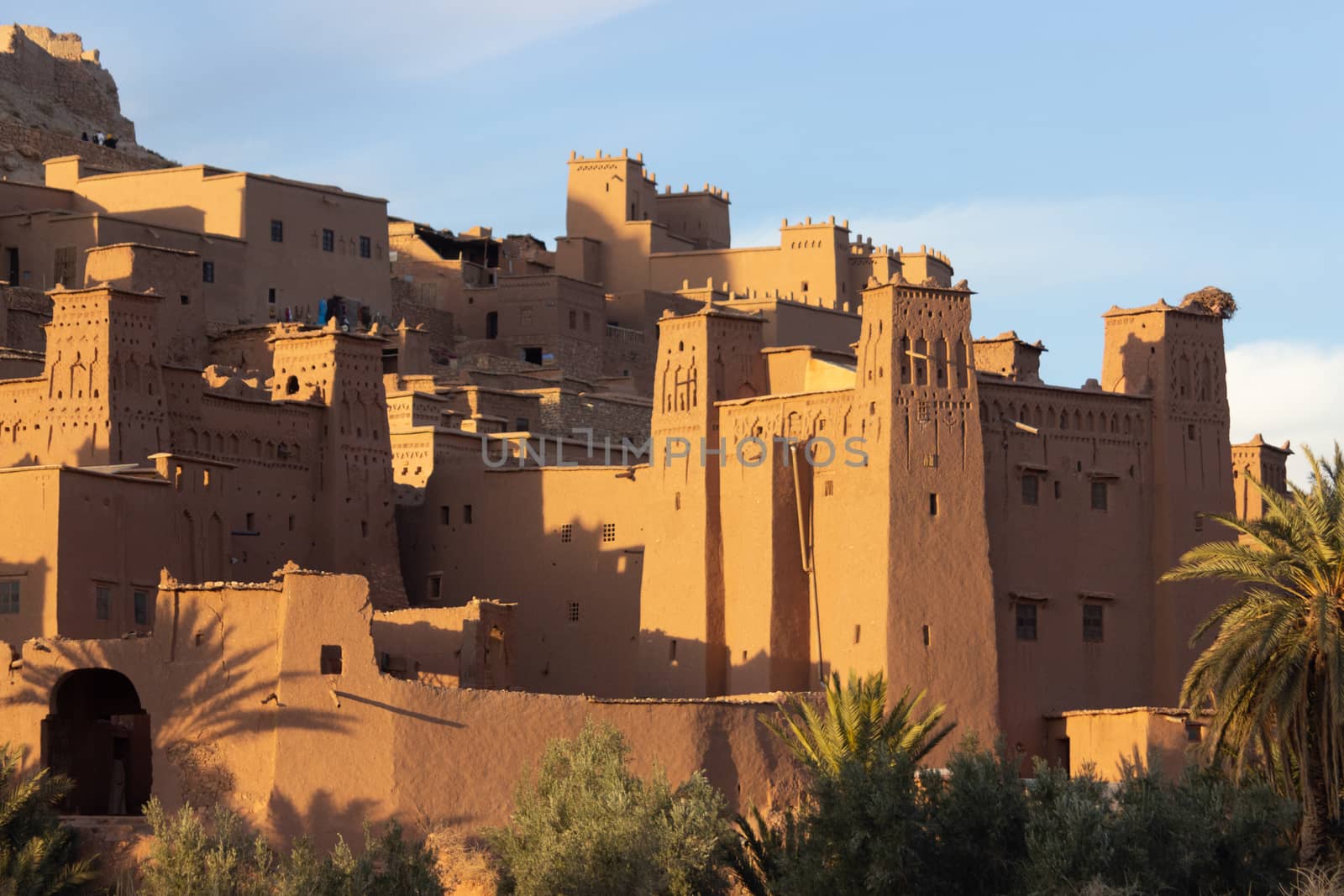 Ait Ben Haddou ksar Morocco, ancient fortress that is a Unesco Heritage site. Beautiful late afternoon light with honey, gold coloured mud brick construction the kasbah, or fortified town dates from 11th cent. and is on the former caravan route from the Sahara and Marrakech. The location has been used for many famous movies. High quality photo