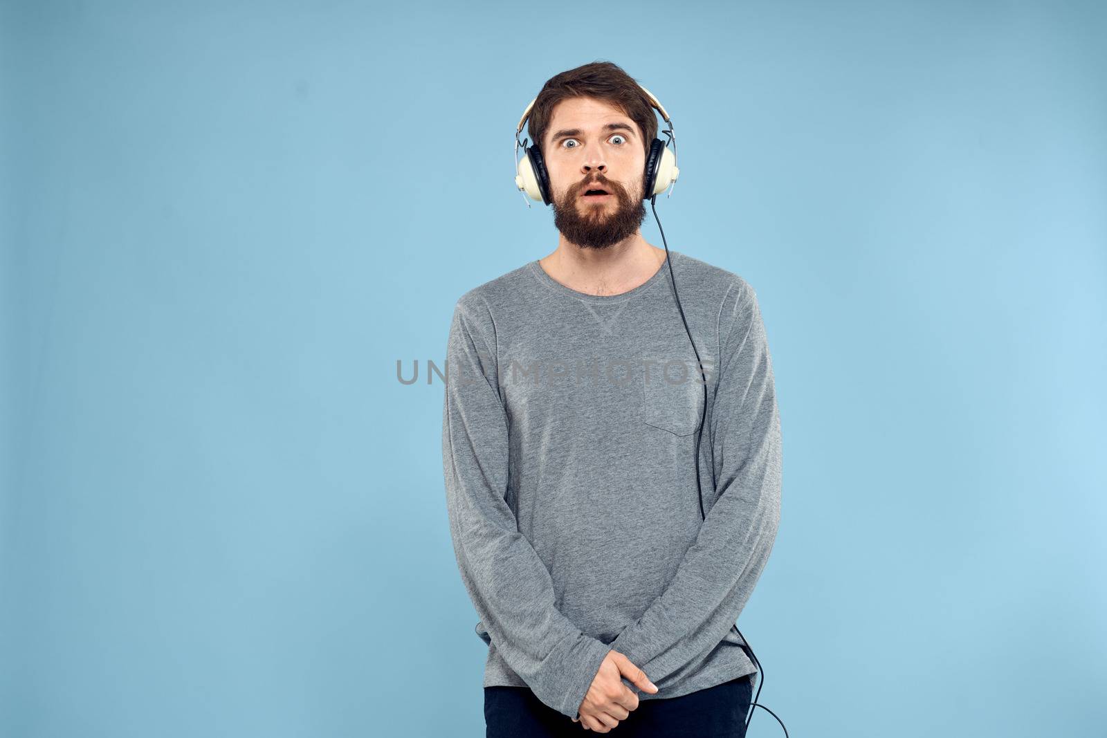 man wearing headphones music emotion lifestyle modern style technology blue background. High quality photo