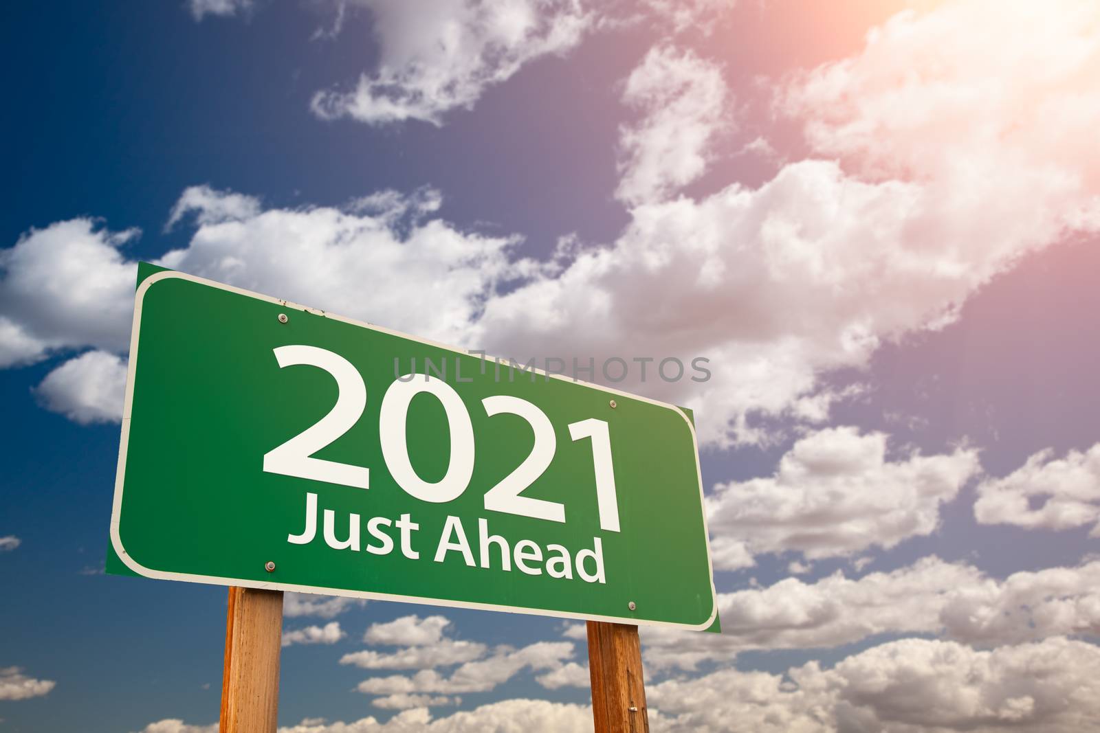 2021 Green Road Sign Over Dramatic Clouds and Sky by Feverpitched