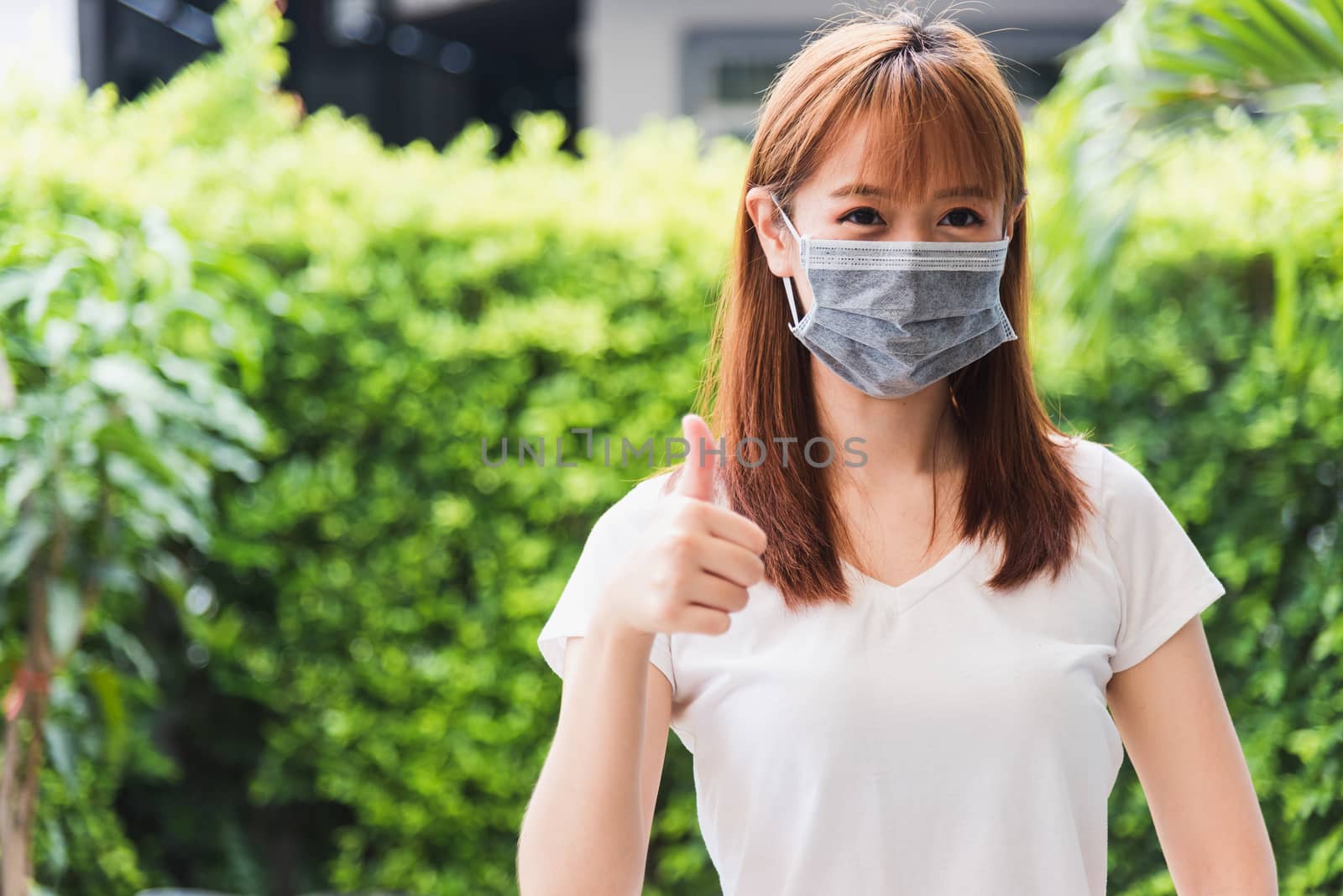 woman wearing face mask protective outdoor by Sorapop