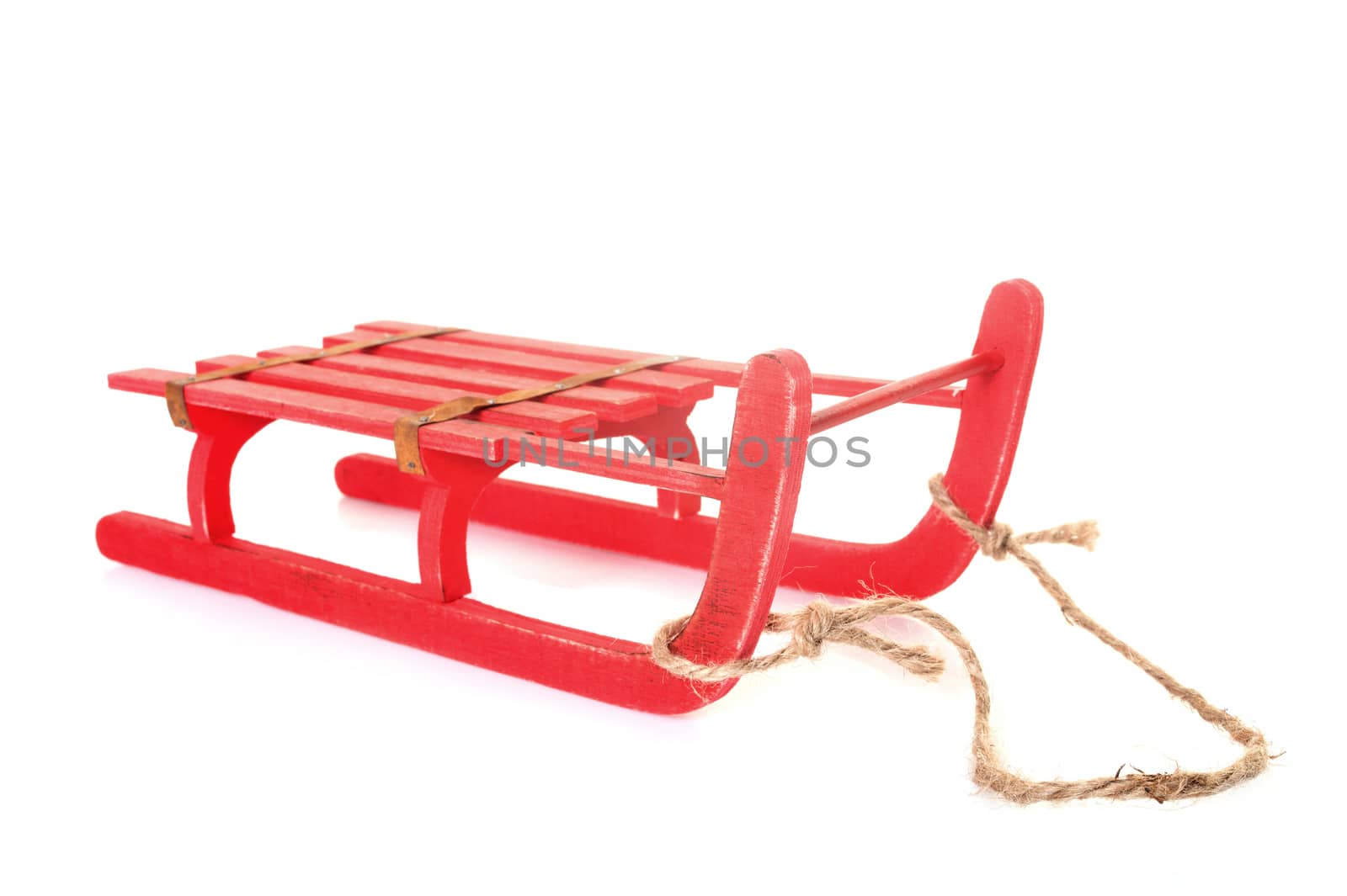 red sledge in front of white background