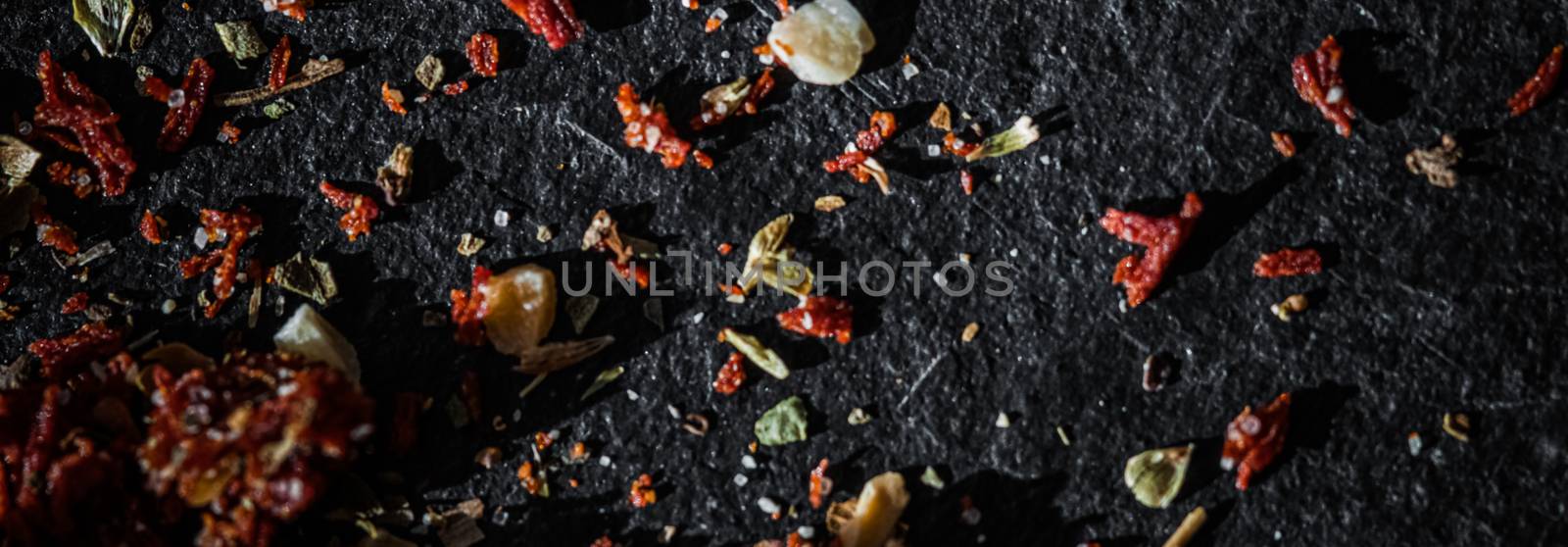 Dried tomato and chili pepper closeup on luxury stone background as flat lay, dry food spices and recipe ingredient by Anneleven