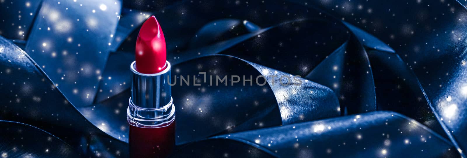 Red lipstick on blue silk and shiny glitter background, luxury make-up and beauty cosmetics