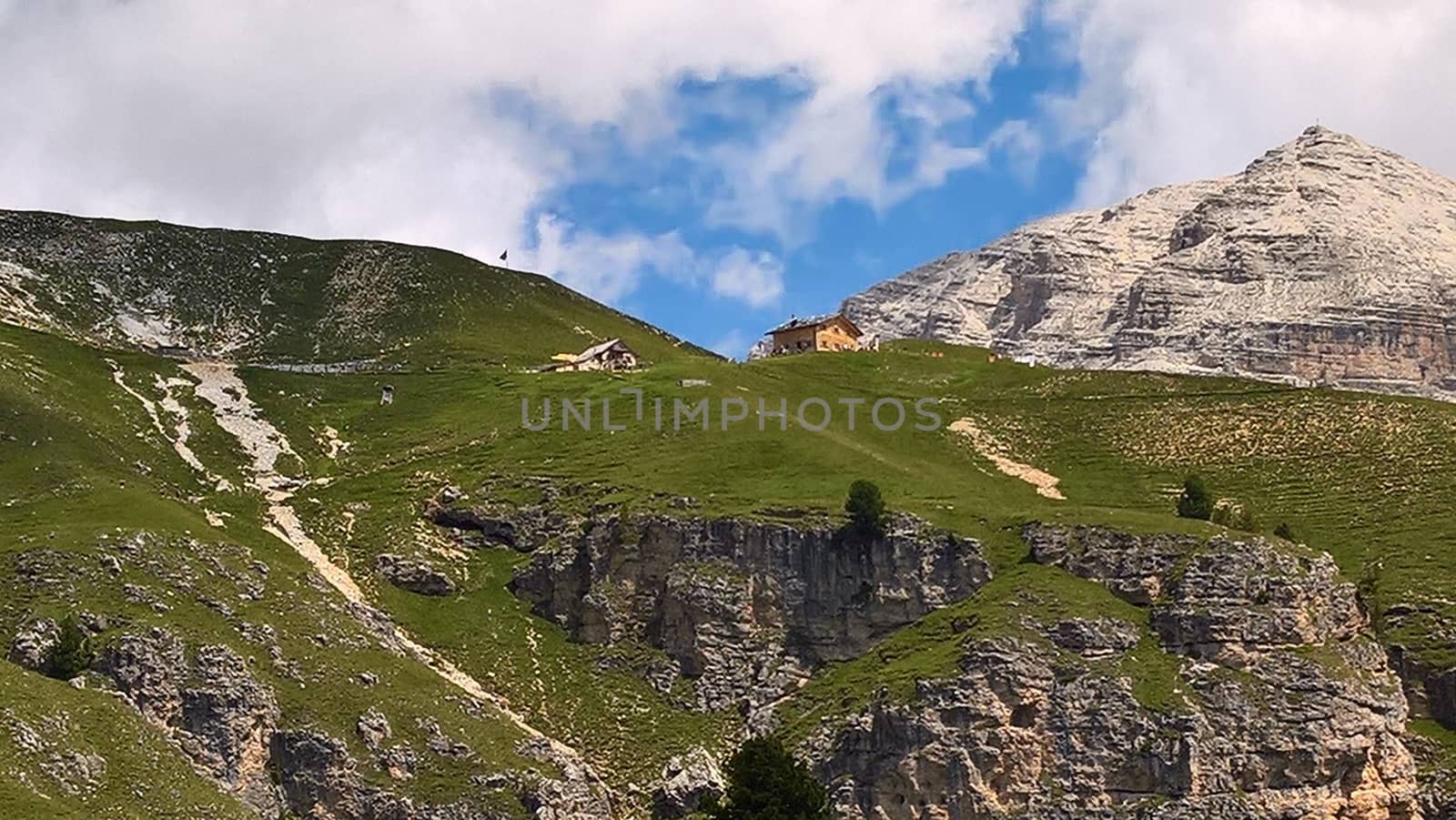 Val Gardena, Italy - 09/15/2020: Scenic alpine place with magical Dolomites mountains in background, amazing clouds and blue sky in Trentino Alto Adige region, Italy, Europe