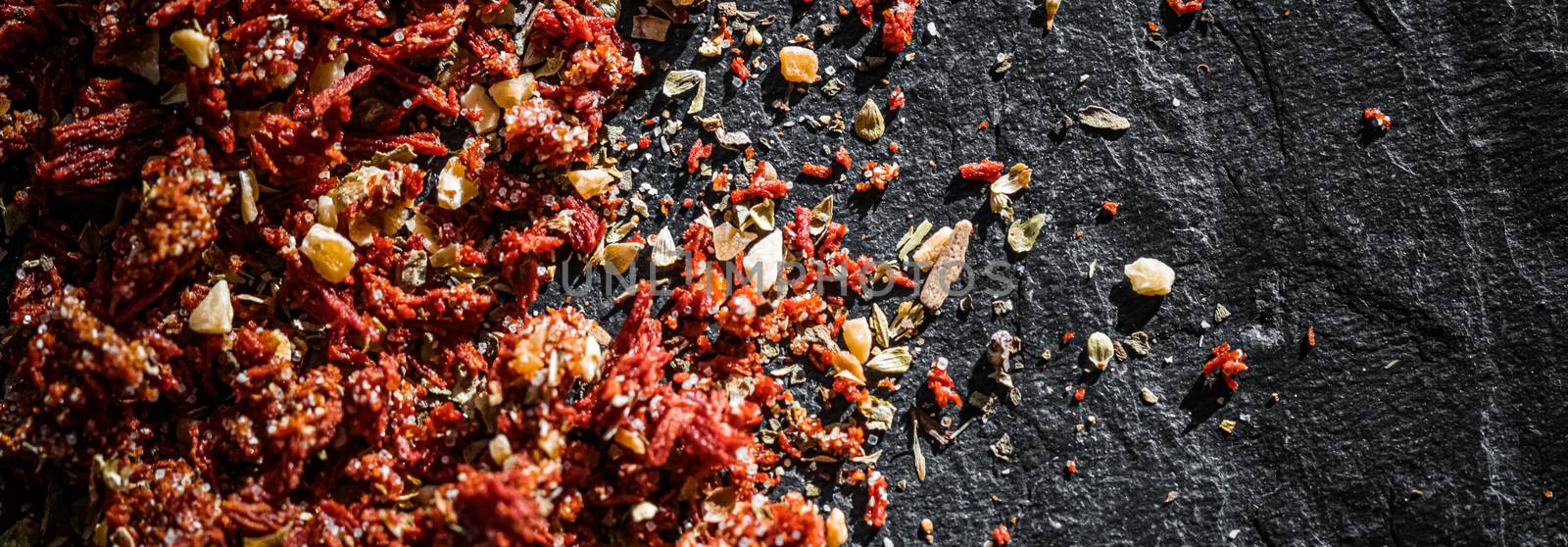 Dried tomato and chili pepper closeup on luxury stone background as flat lay, dry food spices and recipe ingredient by Anneleven