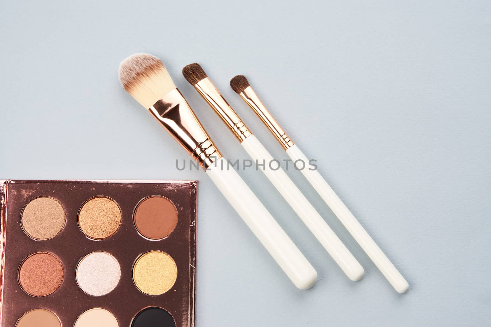 palette with eyeshadows and brushes on gray background cropped view Copy Space. High quality photo