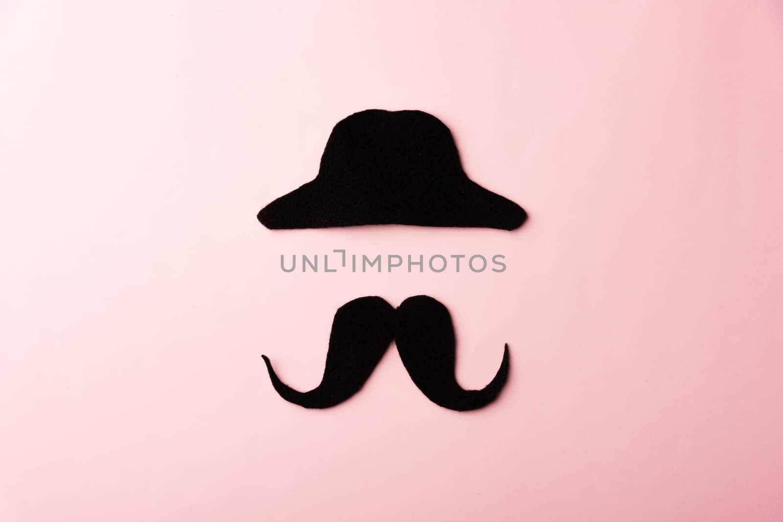 Black mustache and cap, studio shot isolated on pink background, Prostate cancer awareness month, Fathers day, minimal November moustache concept