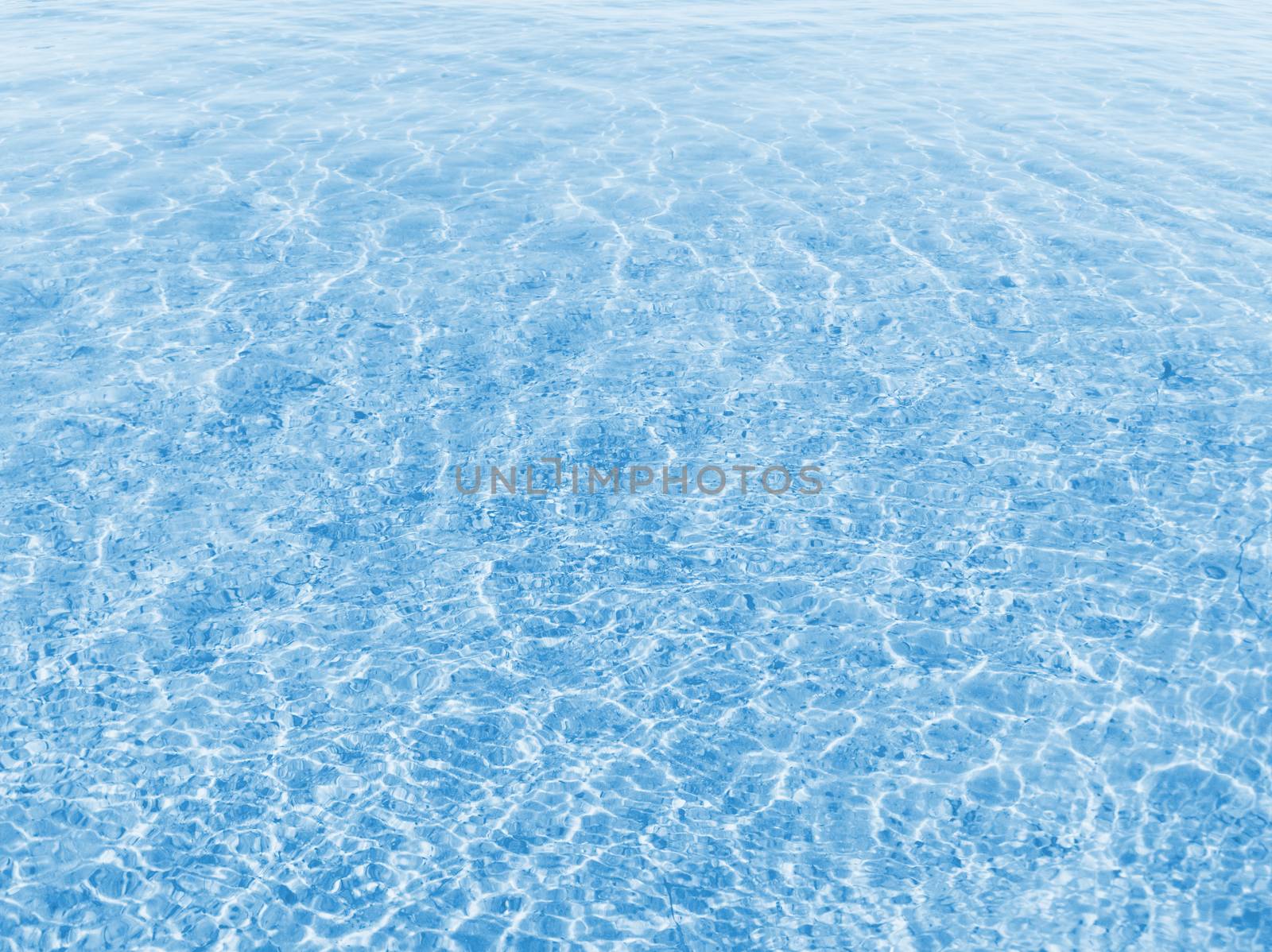 Blue water texture with small waves in sunny day. Stock photography.