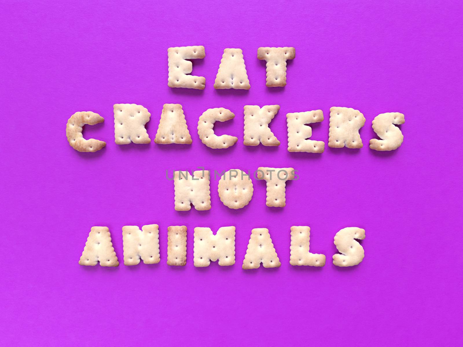 Eat crackers, not animals. Food typography on pink background. Vegan concept. Stock photo. by anna_artist