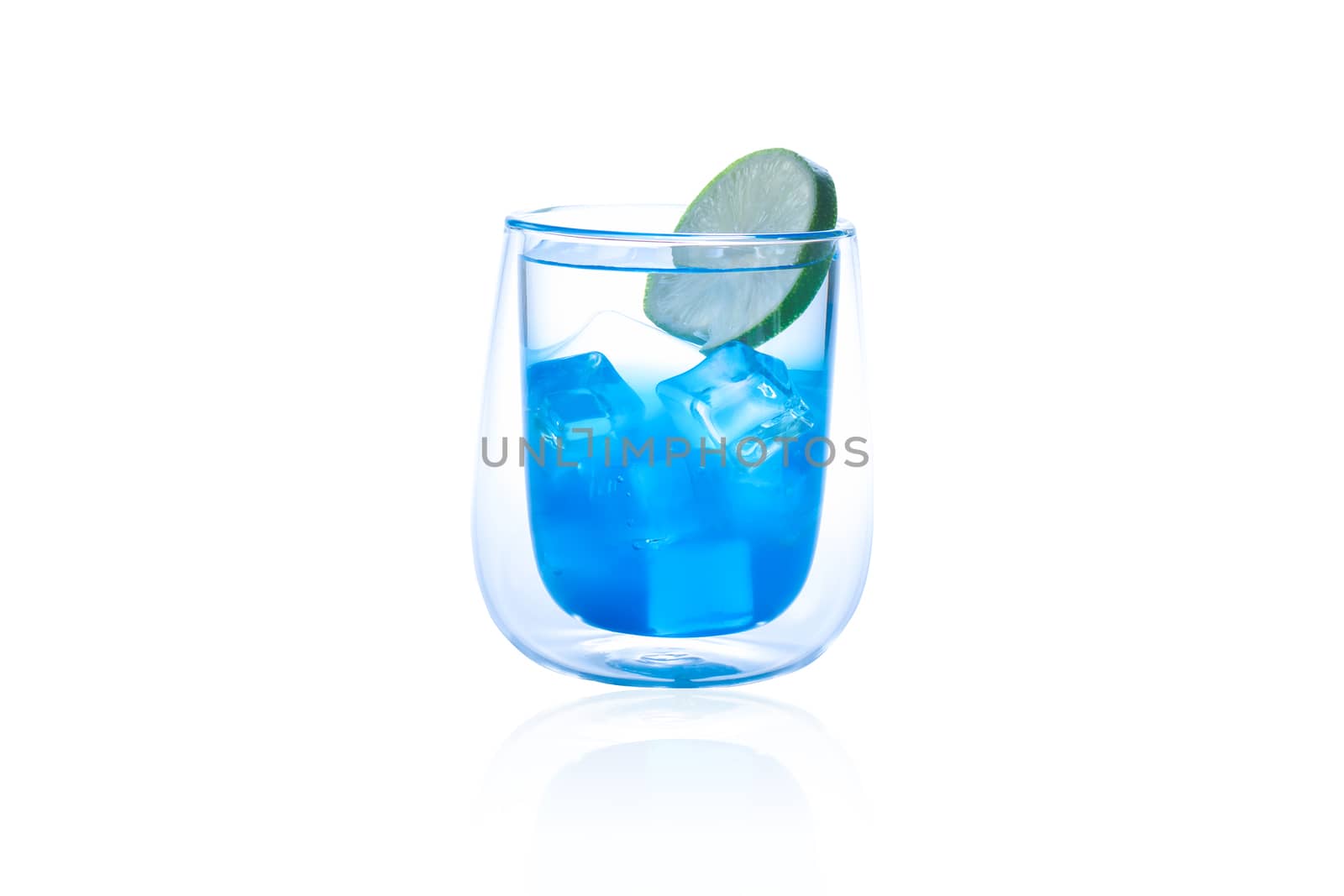 Summer beverage concept. Blue Hawaii drink in glass with lime slice by iiinuthiii