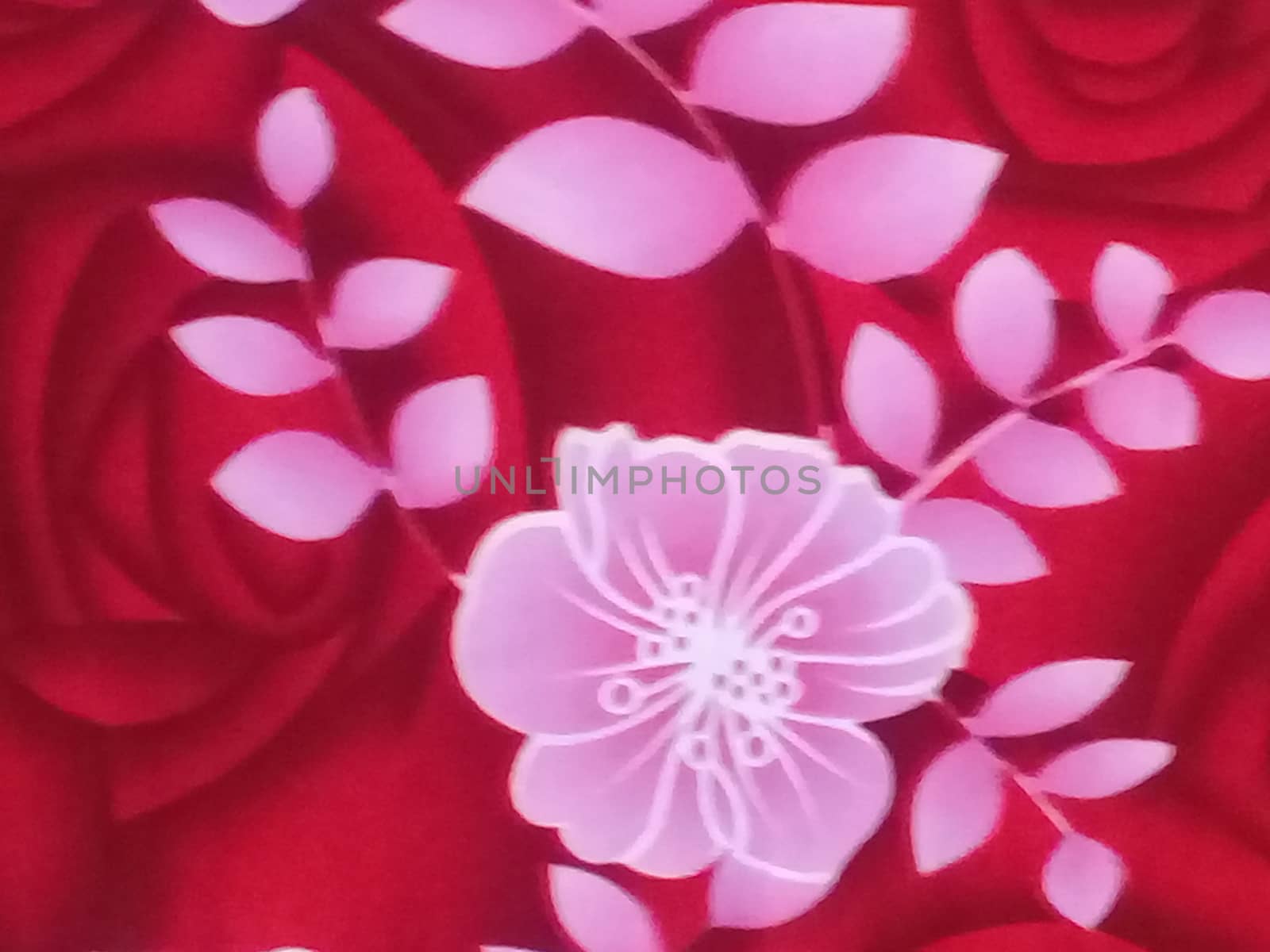 white flower art work on red bedsheets