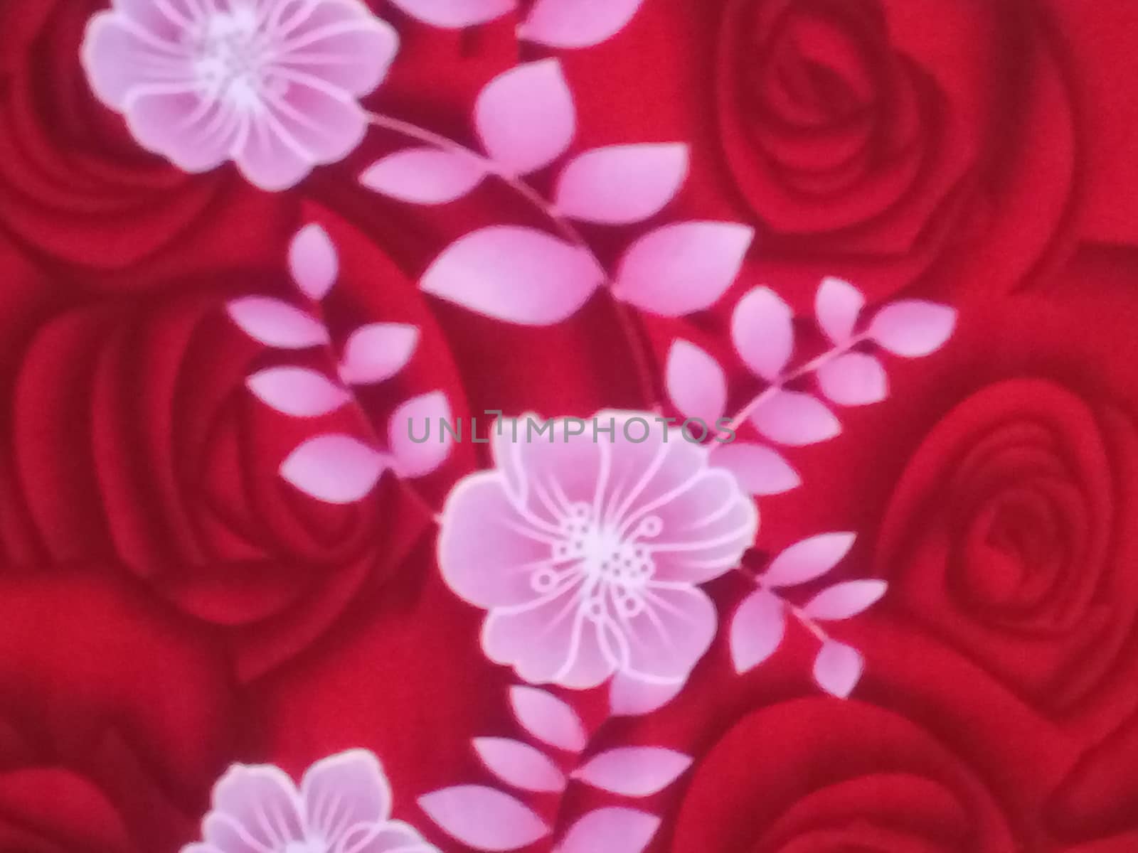 white flower art work on red bedsheets