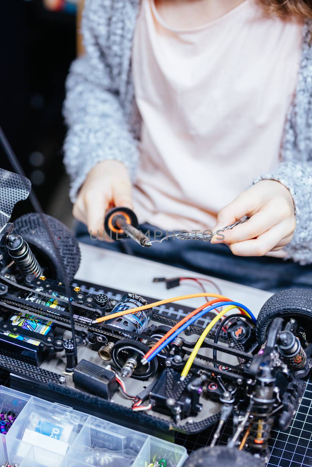 Young Female Child Soldering New Motor Leads by FiledIMAGE