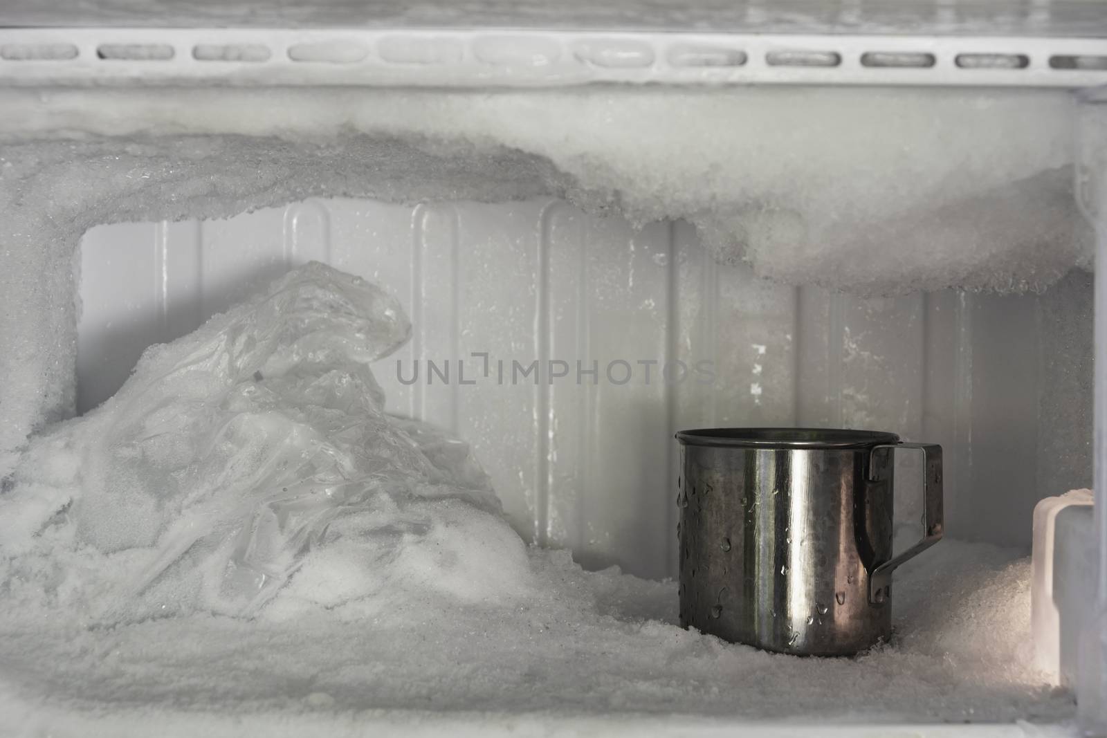 Stainless steel drinking water glass in freezer of a refrigerato by kirisa99