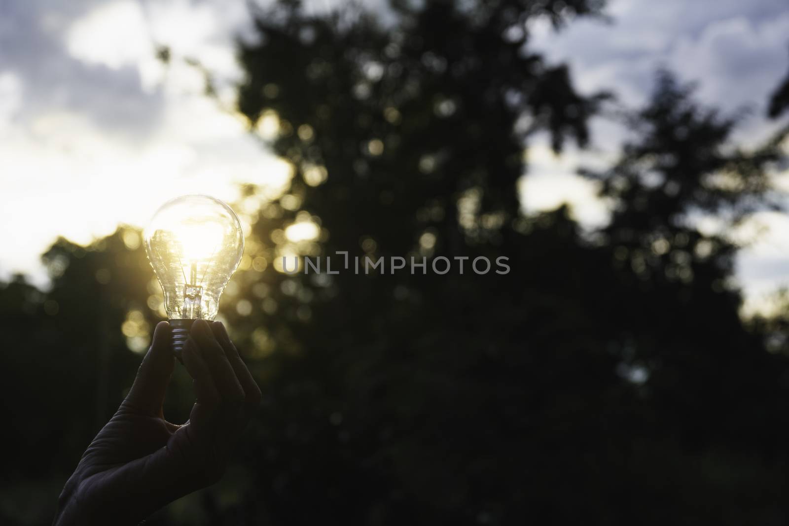 Innovation and energy concept of hand hold a light bulb and copy by kirisa99