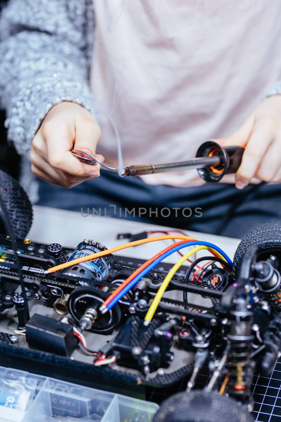 Young Female Child Soldering New Motor Leads by FiledIMAGE