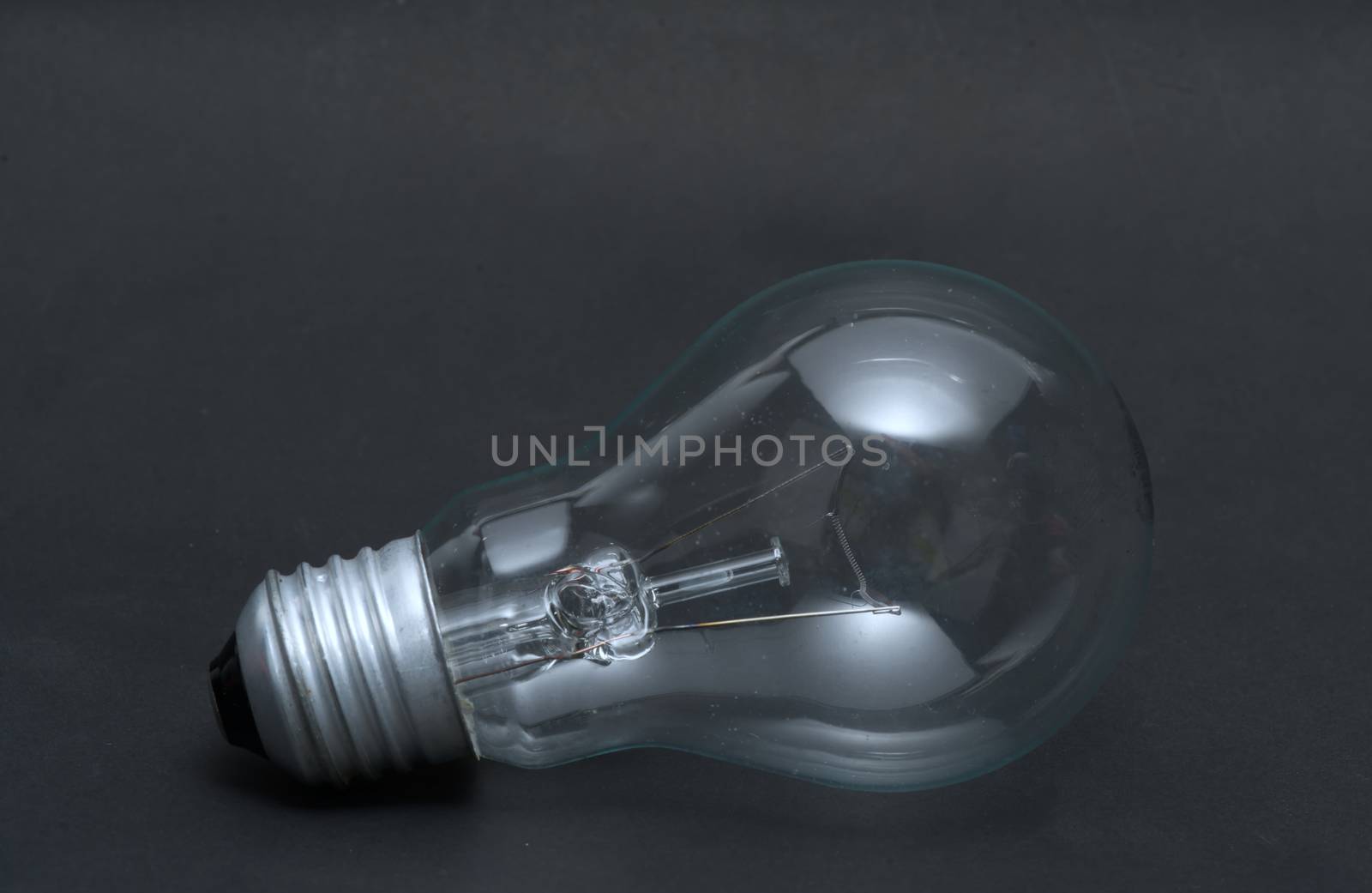 Abstract previously used light bulb concept on black isolated ba by noppha80