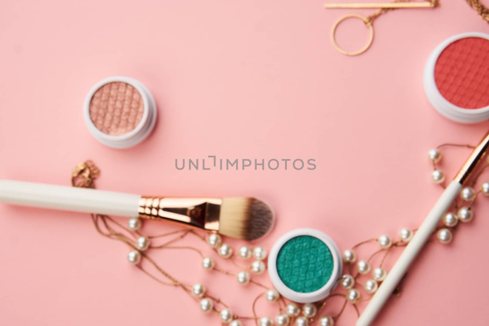 makeup brushes and eyeshadow professional cosmetics on pink background. High quality photo