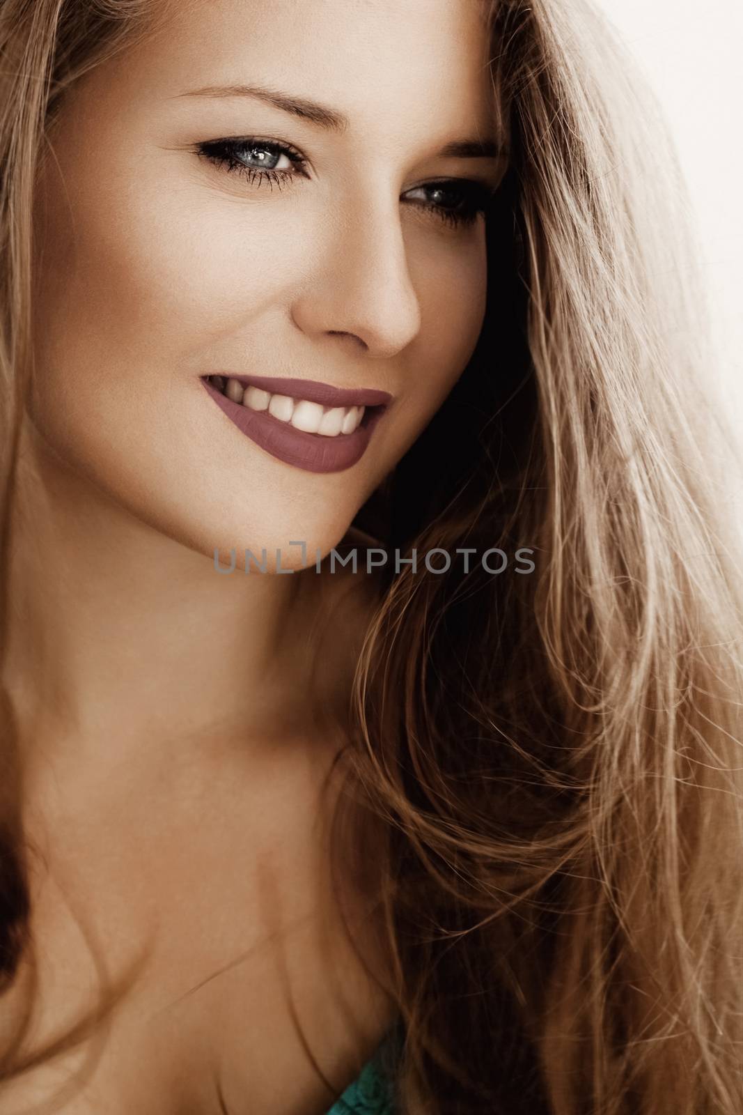 Charming woman smiling, brunette with long light brown hair, natural makeup look, female showing healthy white teeth, beauty portrait for cosmetic or lifestyle brands