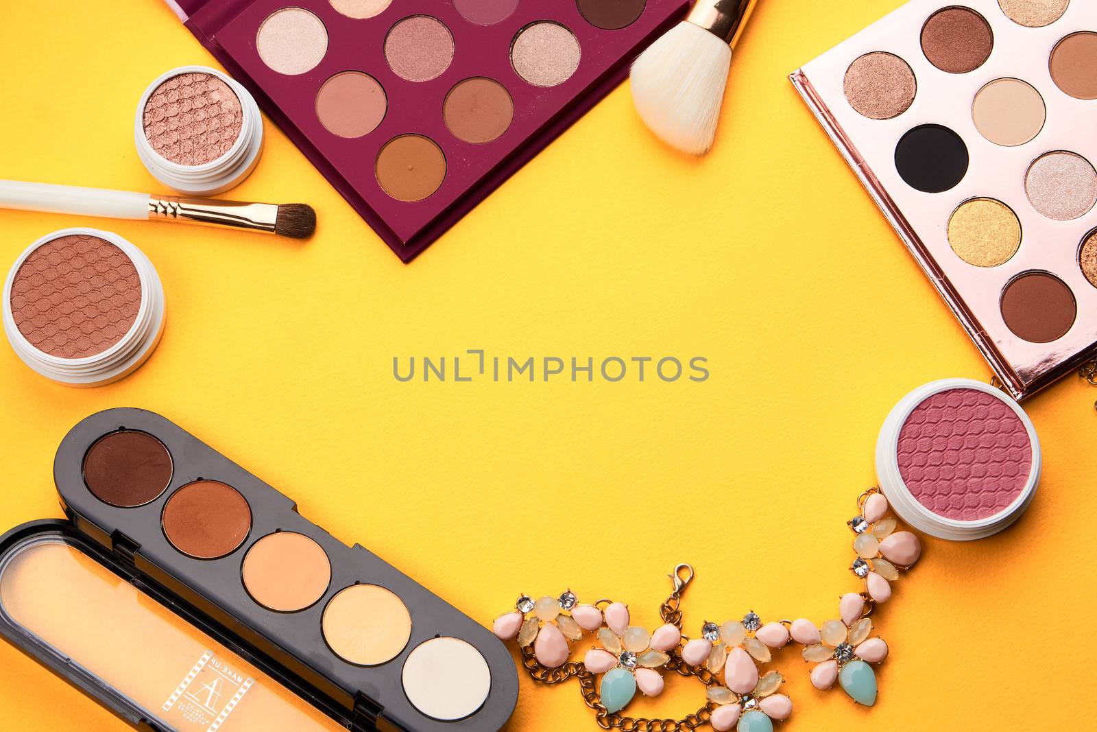 eyeshadow professional cosmetics blush powder yellow background top view. High quality photo