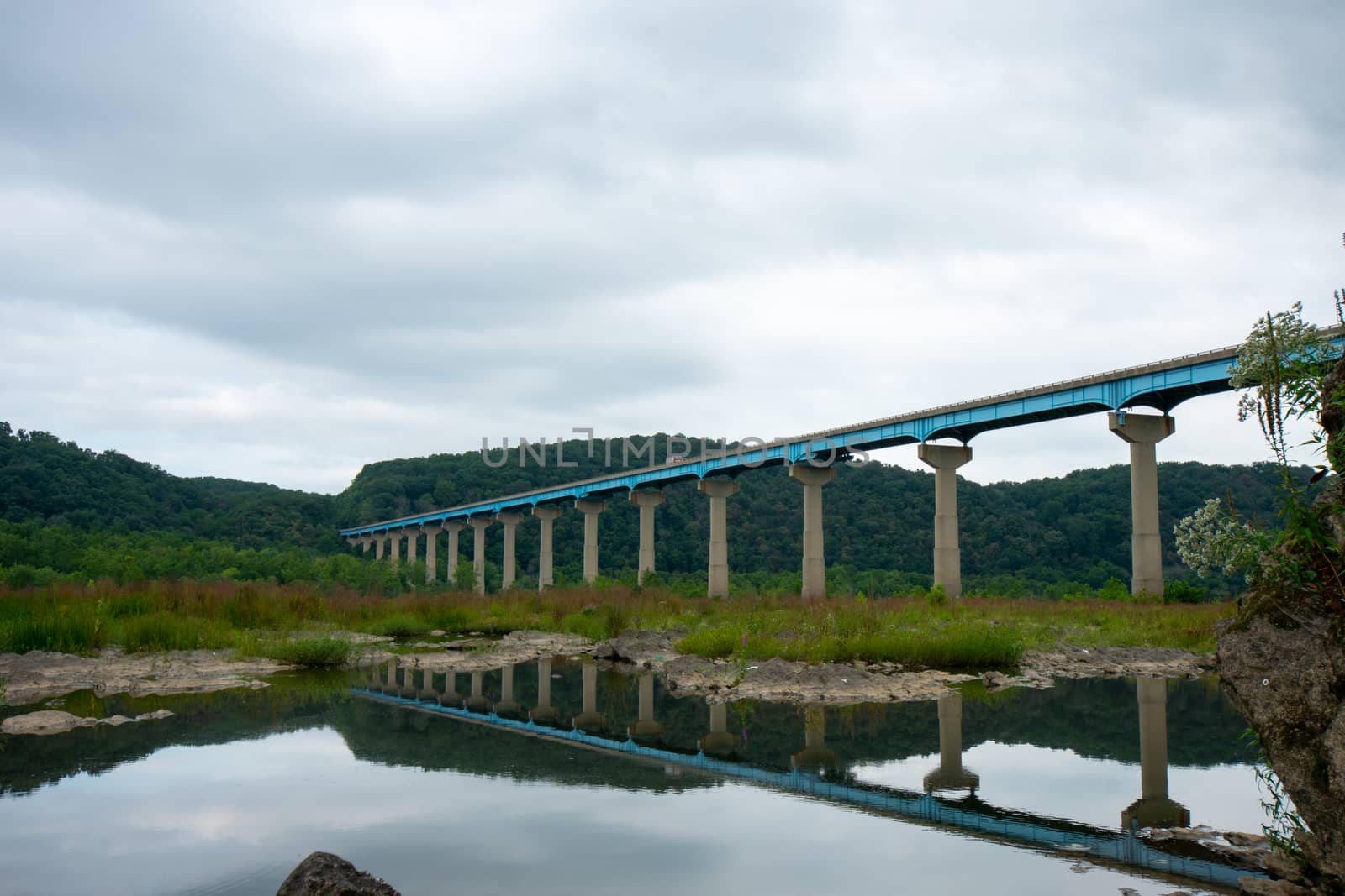 The Norman Wood Bridge OVer the Susquehanna River Reflecting Itself in a Small Body of Water on a Cloudy Day