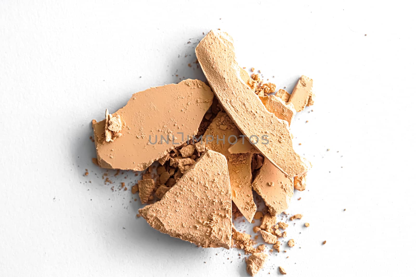 Beige eye shadow powder as makeup palette closeup isolated on white background, crushed cosmetics and beauty textures