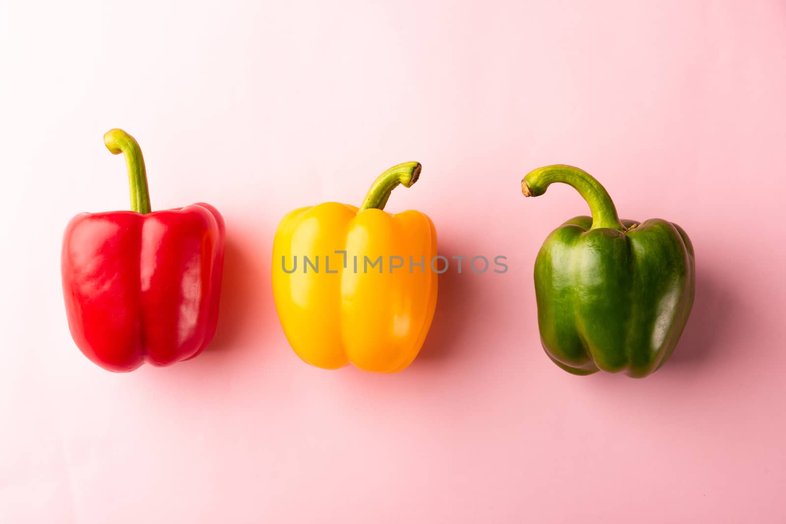 raw red, yellow and green bell peppers by Sorapop