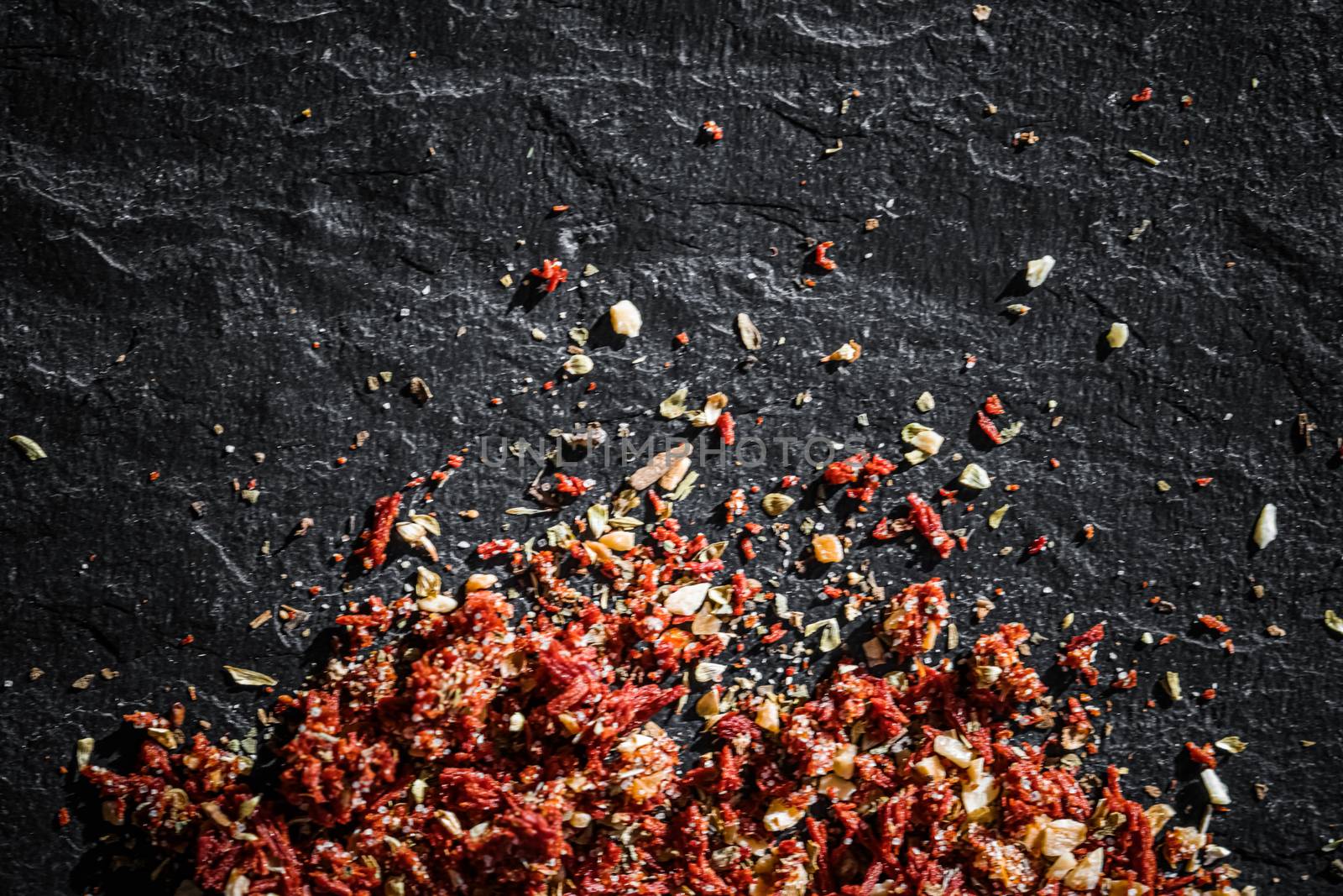 Dried tomato and chili pepper closeup on luxury stone background as flat lay, dry food spices and recipe ingredient by Anneleven