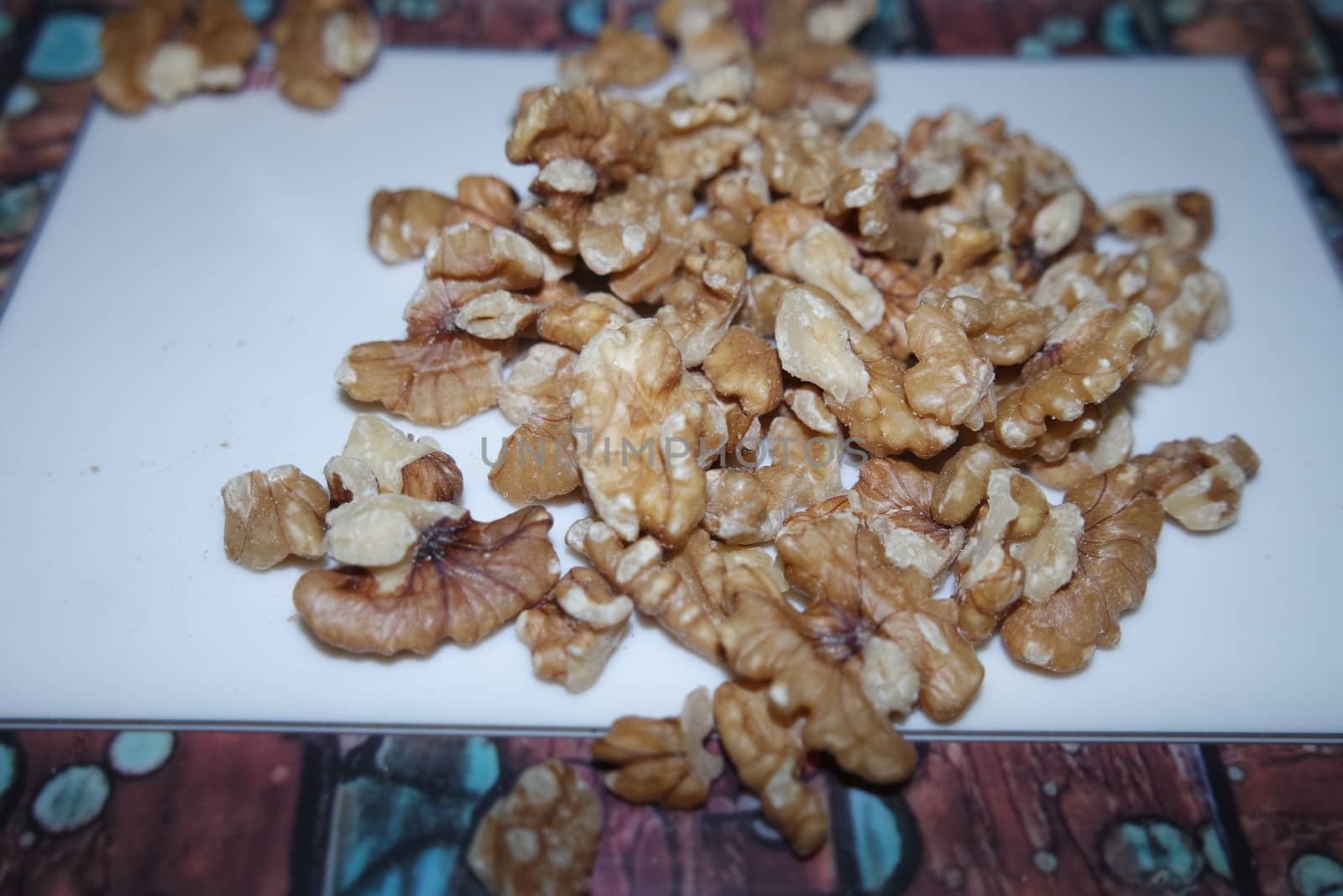 Close-up top view of peeled walnut on a white background. peeled walnut without shell ready to eat dry fruit.