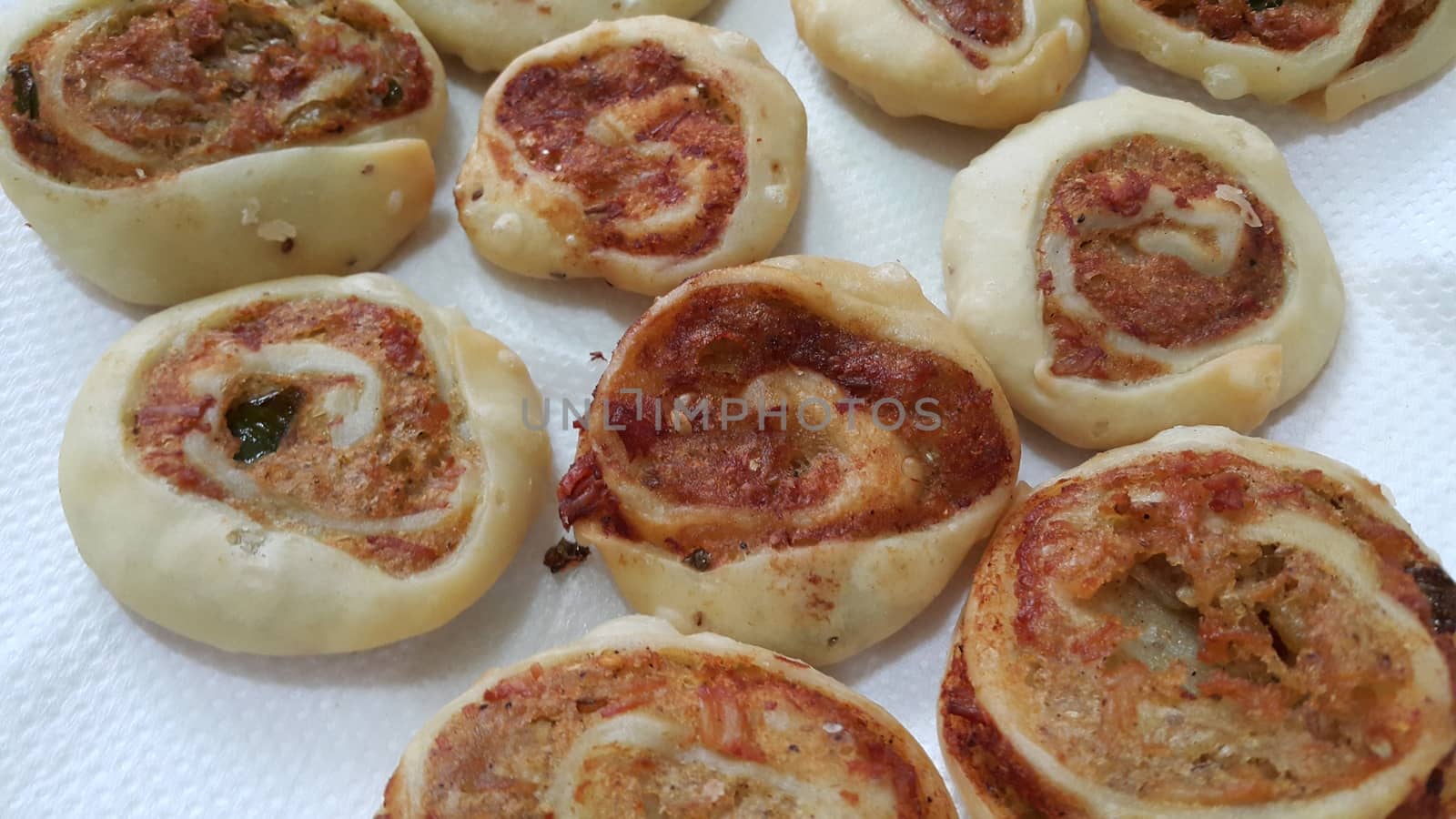 Closeup of delicious home made pinwheel puff pastries food item placed over white background