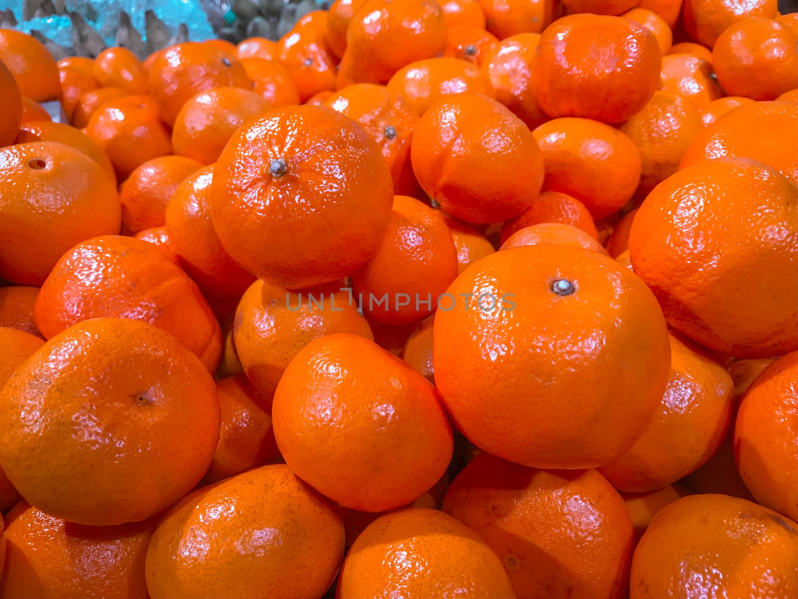 Closeup a pile of oranges in a supermarket.