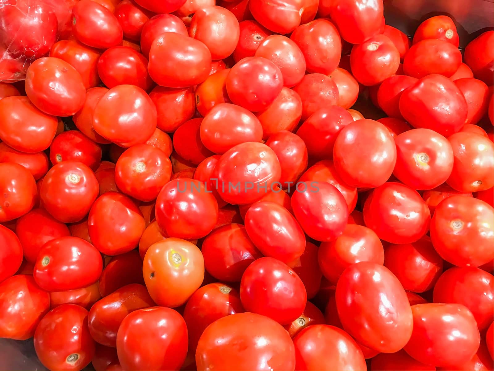 Closeup group of fresh tomato in the market.