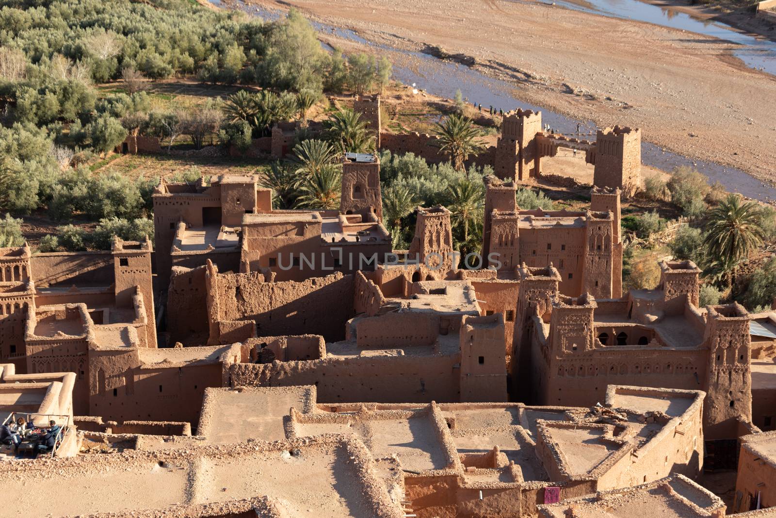 Ait Ben Haddou ksar Morocco, ancient fortress that is a Unesco Heritage site. Beautiful late afternoon light with honey, gold coloured mud brick construction the kasbah, or fortified town dates from 11th cent. and is on the former caravan route from the Sahara and Marrakech. The location has been used for many famous movies. High quality photo