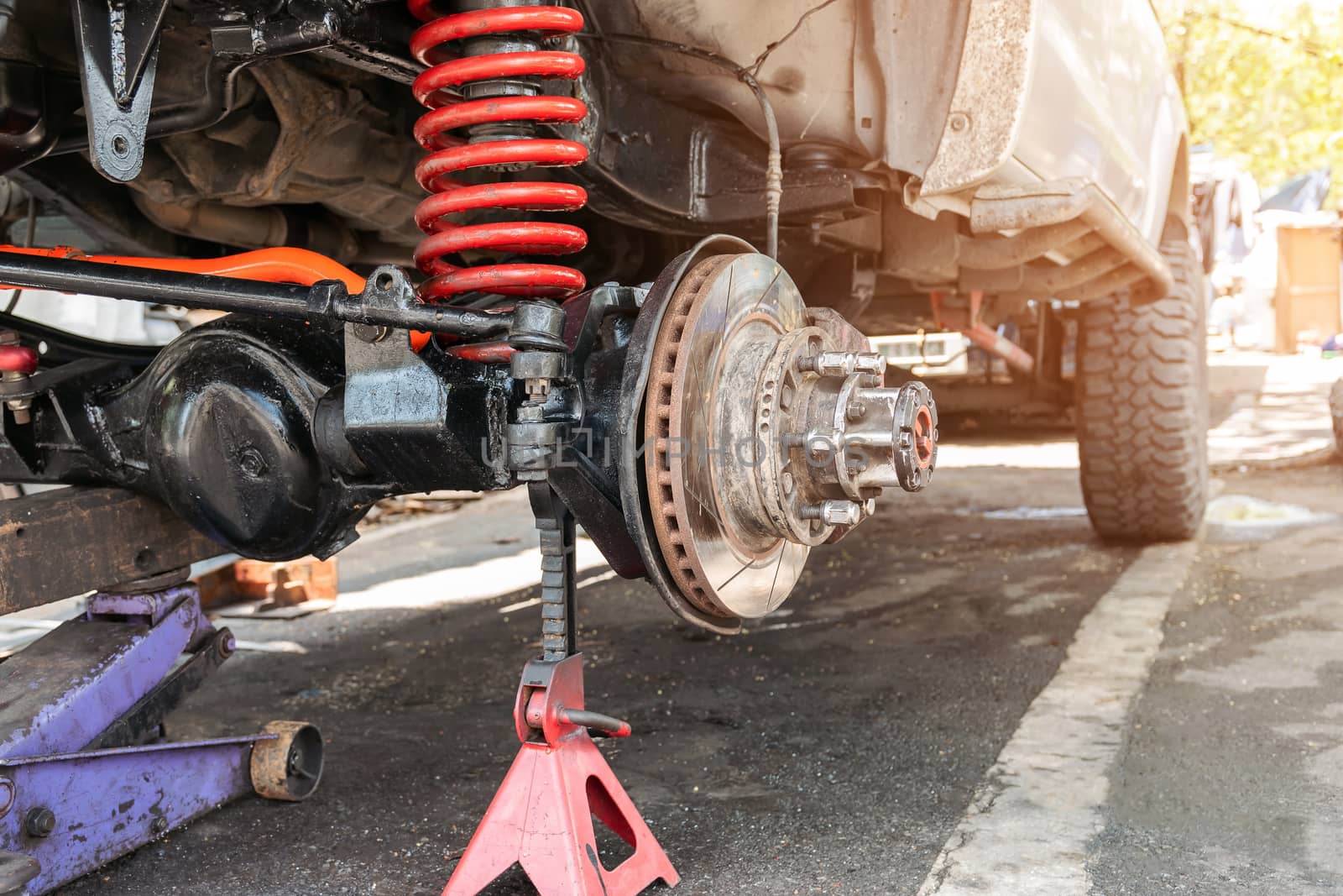 The front wheel of the car was removed to repair the brake system, Automotive industry and garage concepts.