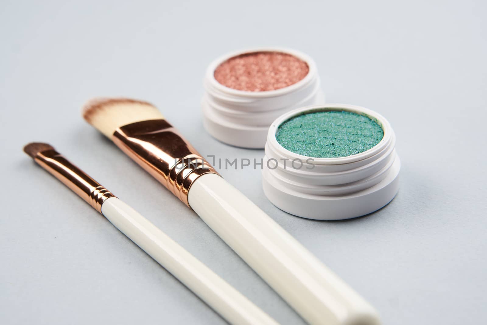 makeup brushes eyeshadow collection professional cosmetics on gray background. High quality photo