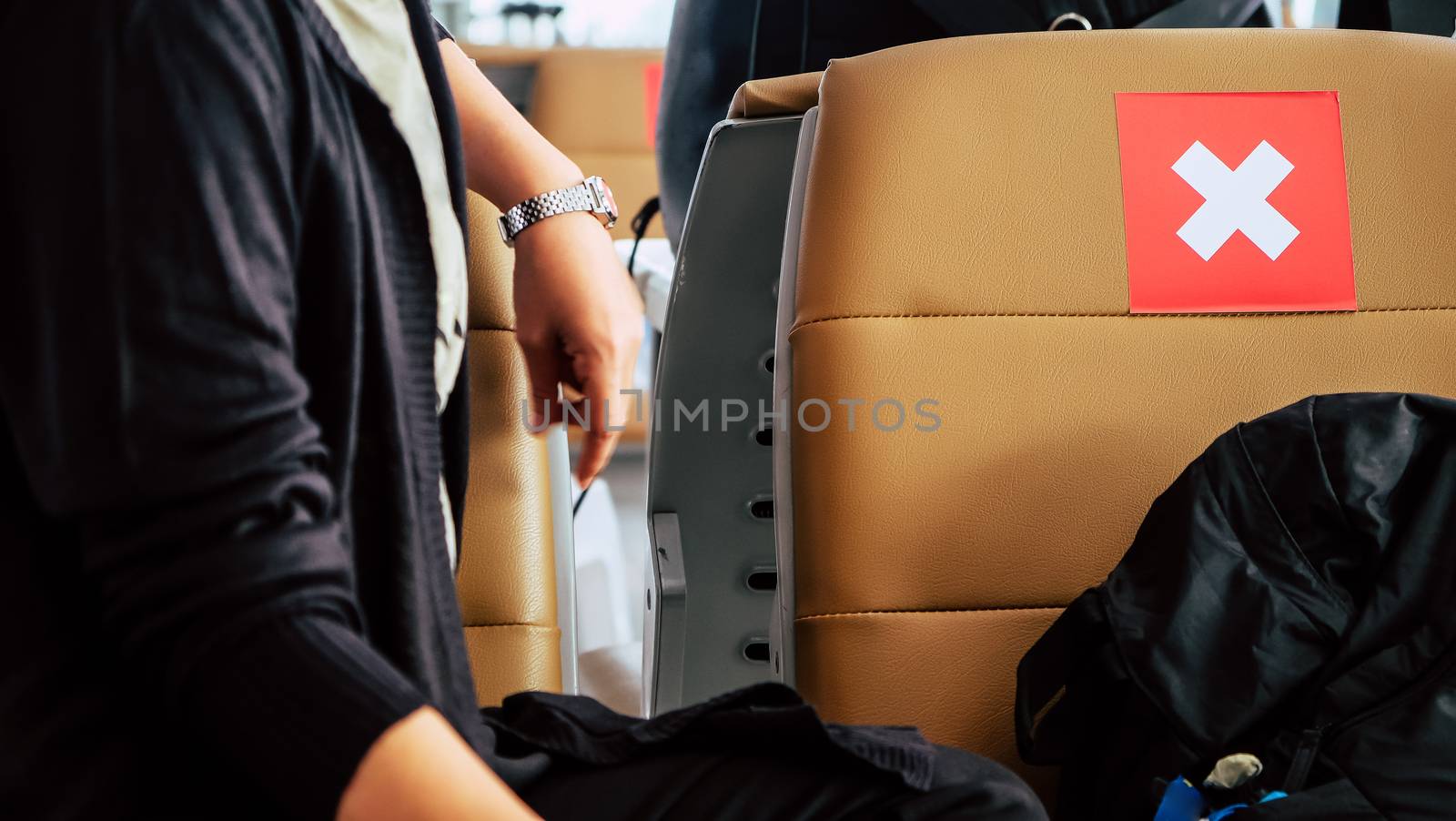 Social distancing, Rows of empty chairs in an airport's departure area marked with symbols regarding social distancing protocol to prevent the spreading of novel corona virus, COVID-19 in Thailand