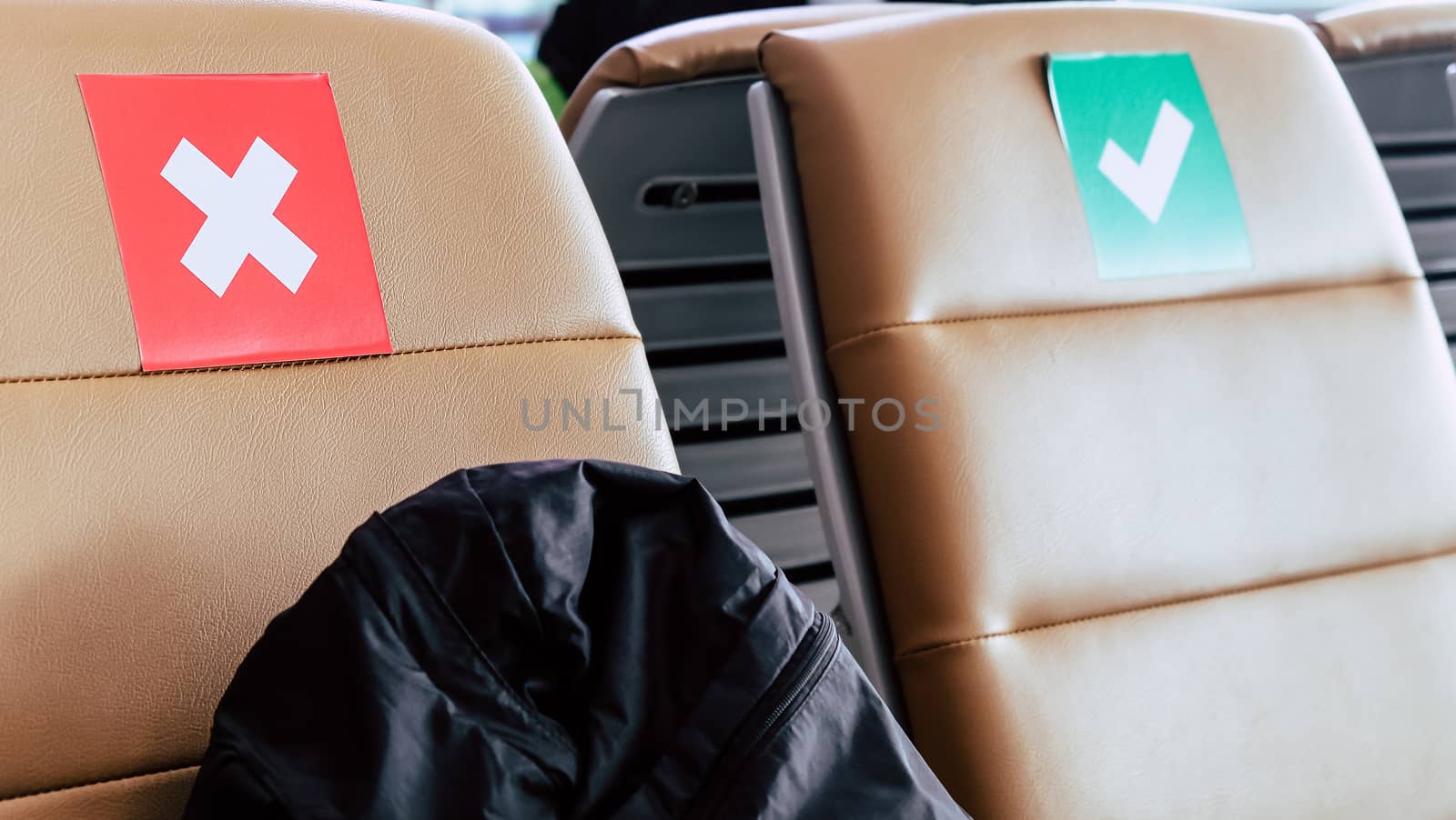Social distancing, Rows of empty chairs in an airport's departure area marked with symbols regarding social distancing protocol to prevent the spreading of novel corona virus, COVID-19 in Thailand