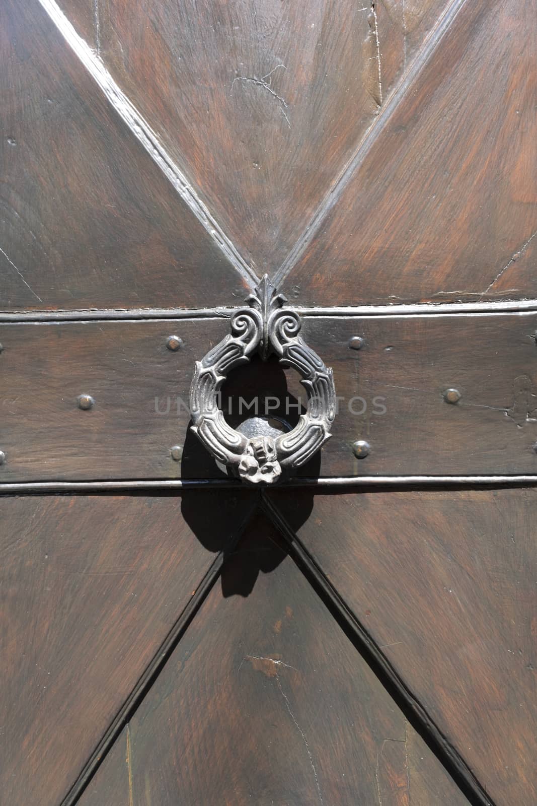 Antique door knocker on wooden door by Tjeerdkruse