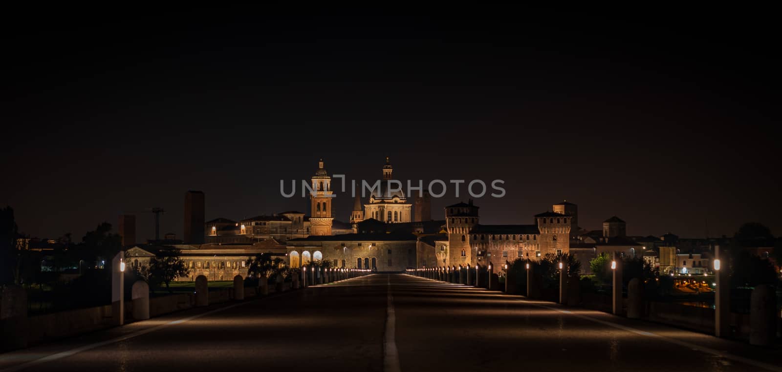 Night view of Mantua city coming from San Giorgio bridge, landscape of historical Lombard city in Italy