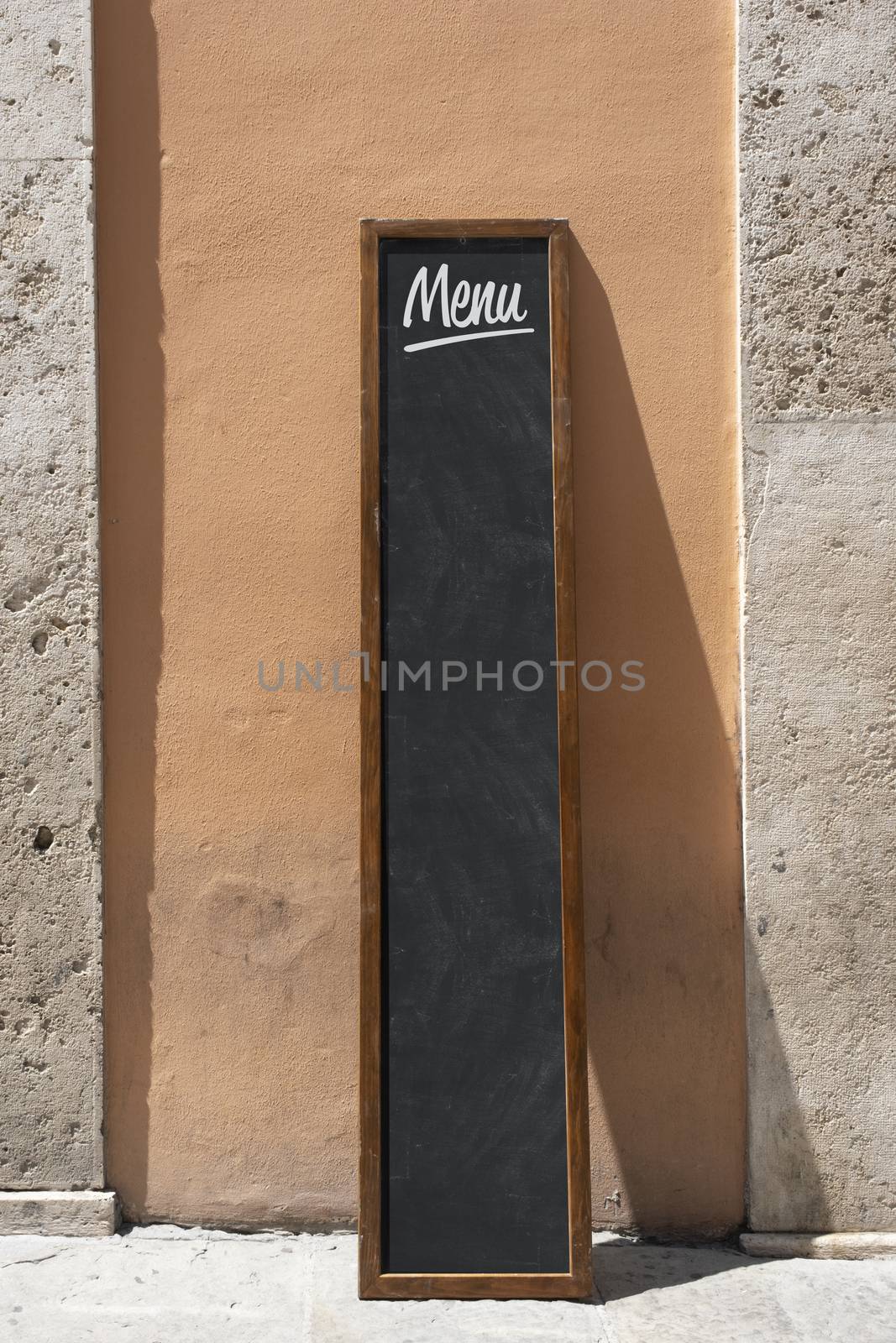 Empty menu board stand and outdoor cafe by Tjeerdkruse