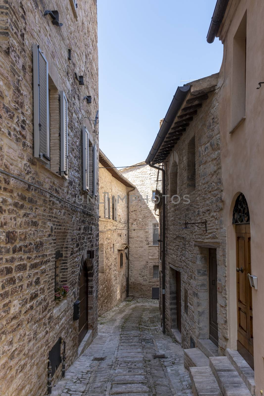 Narrow alley in tuscan village. antique italian lane, Tuscany, Italy by Tjeerdkruse