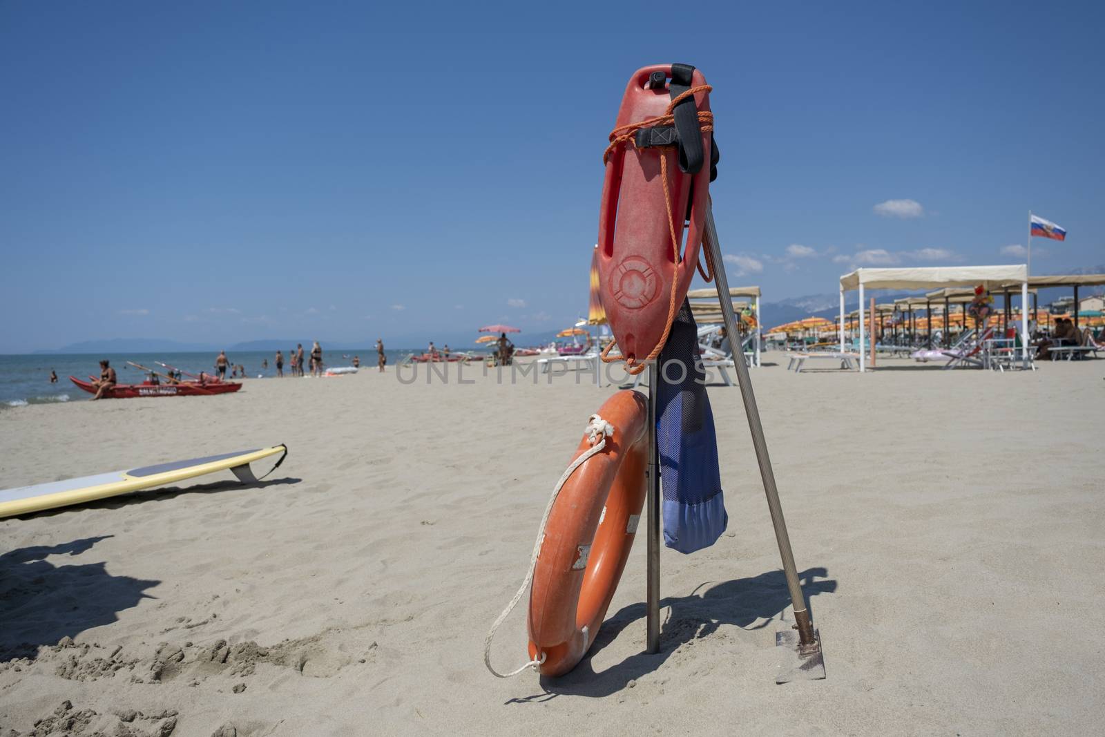 Life preserver on sandy beach somewhere in Tuscane, Italy